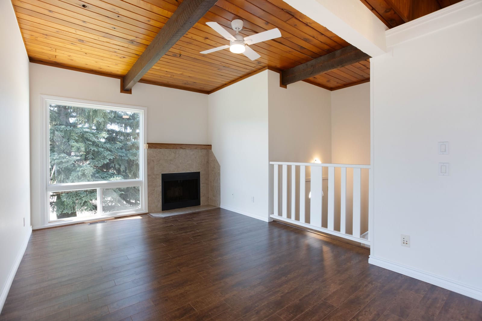 Unfurnished living room with vaulted wood ceiling