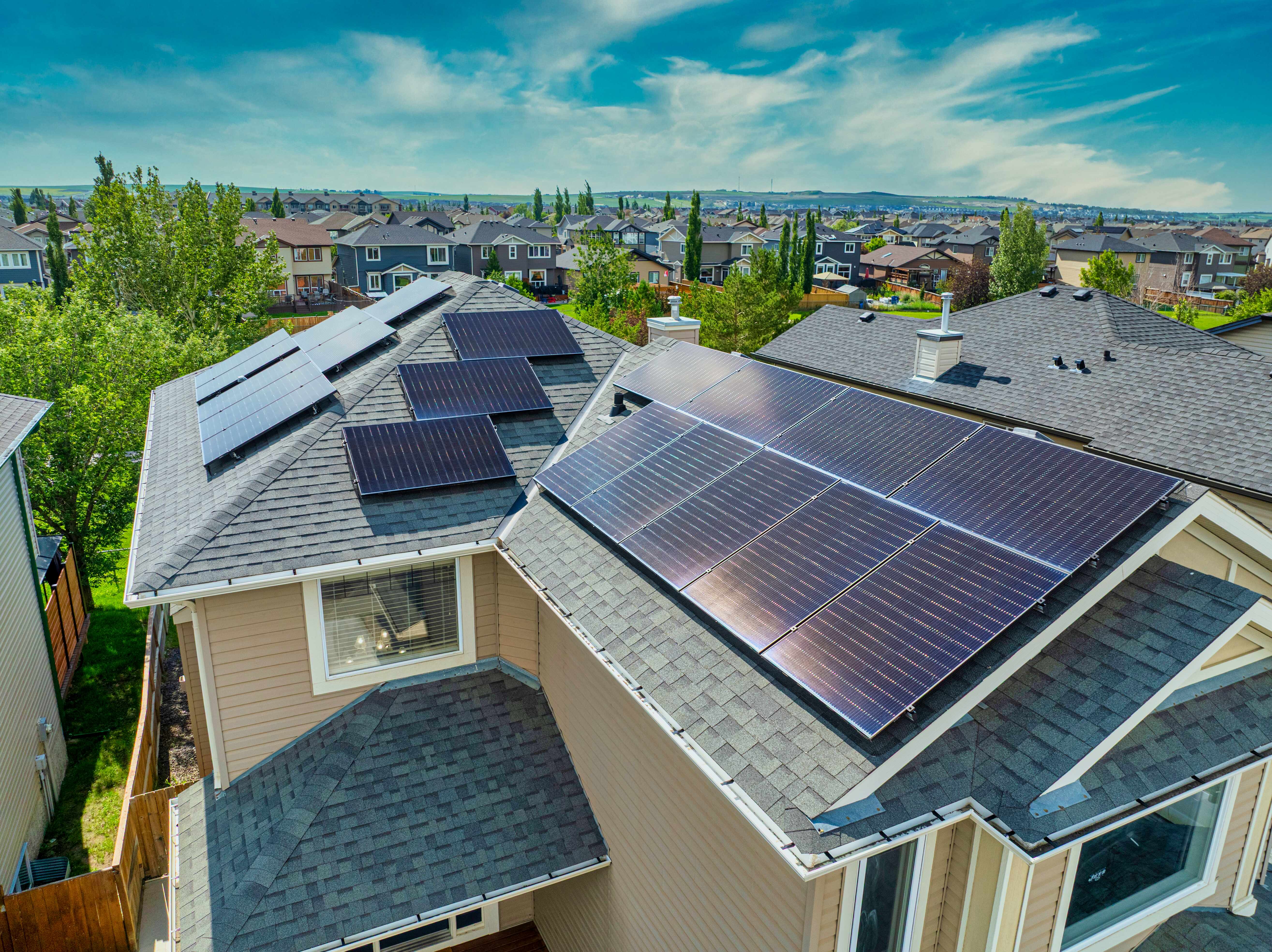 Roof-mounted solar panels and surrounding Luxstone homes