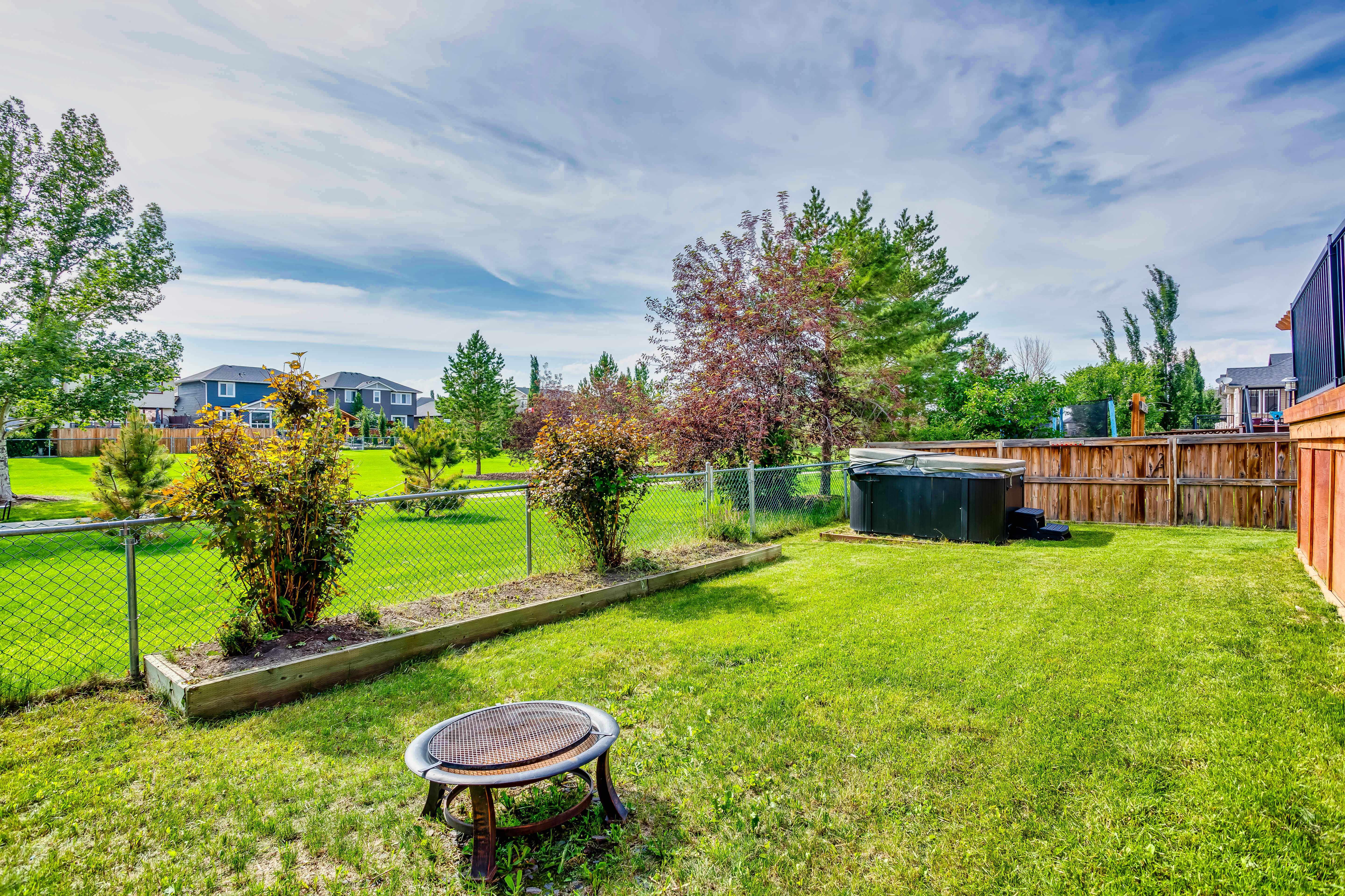 Landscaped backyard with hot tub
