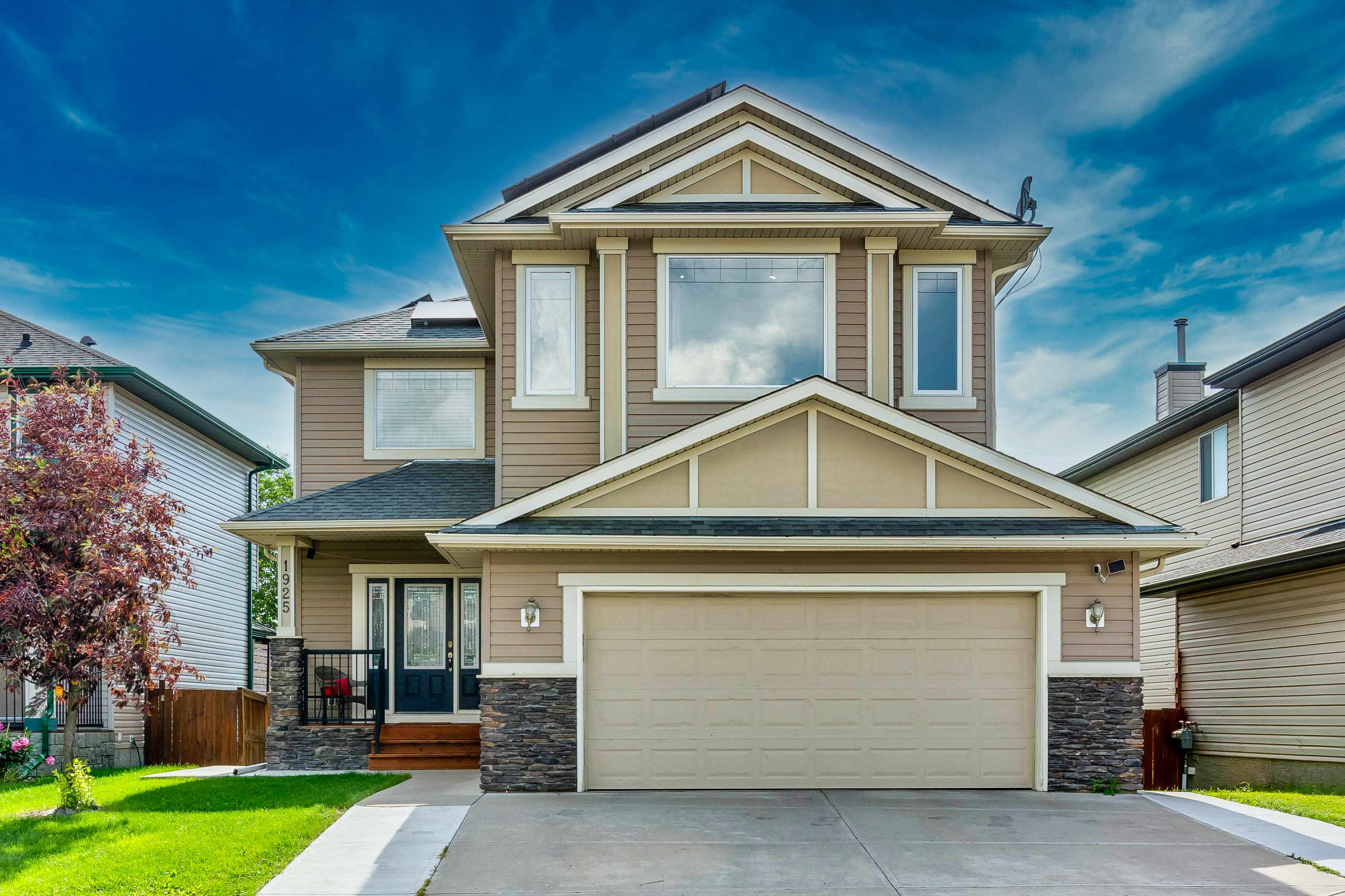 Front exterior with attached double garage