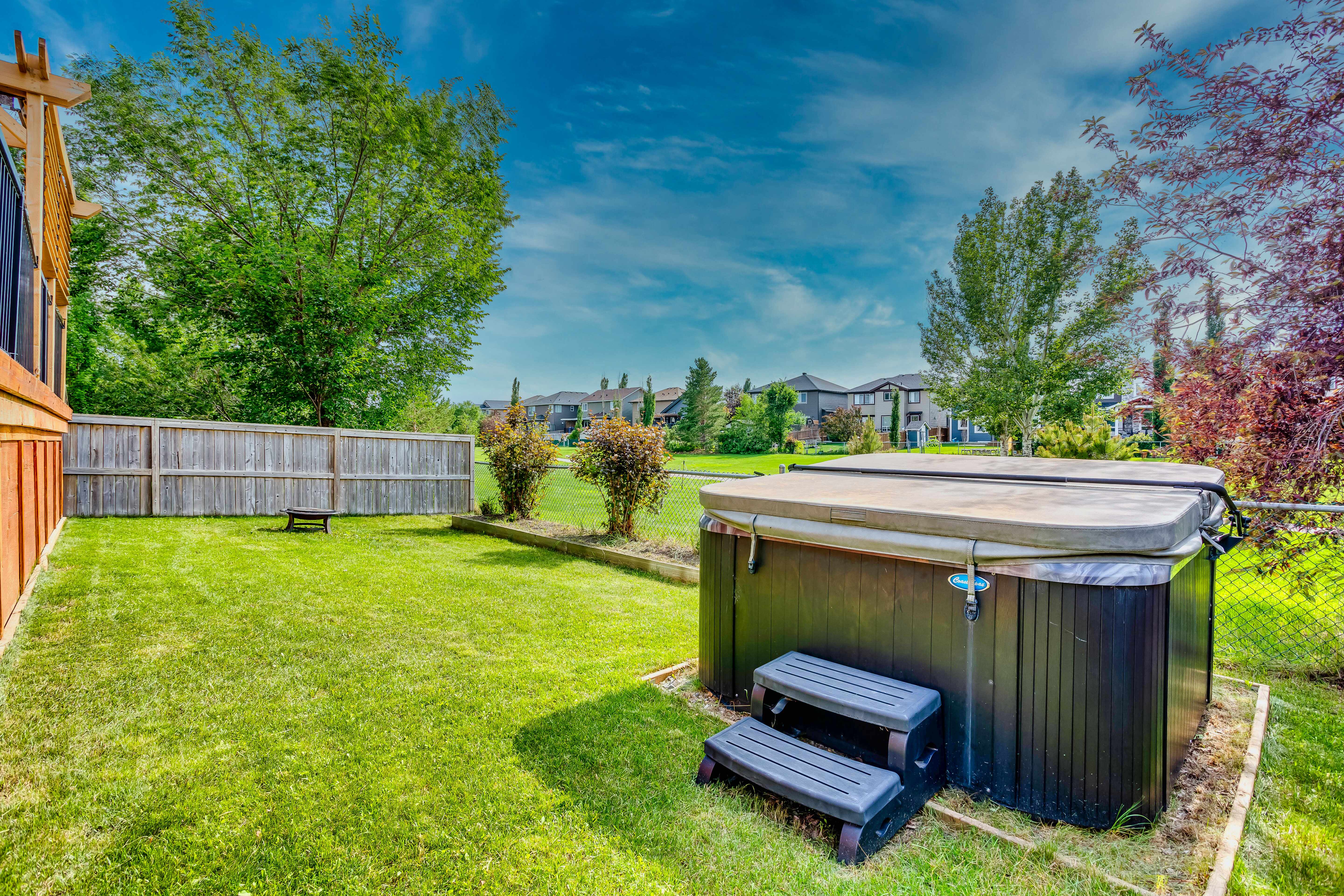Hot tub beside landscaped backyard
