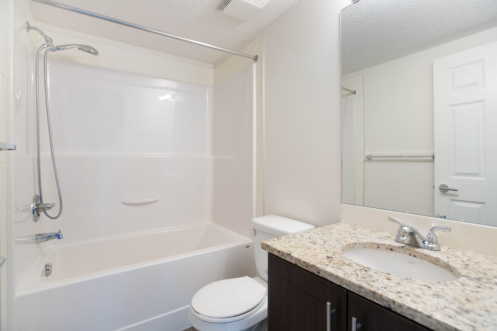 Full bathroom with granite vanity and bathtub