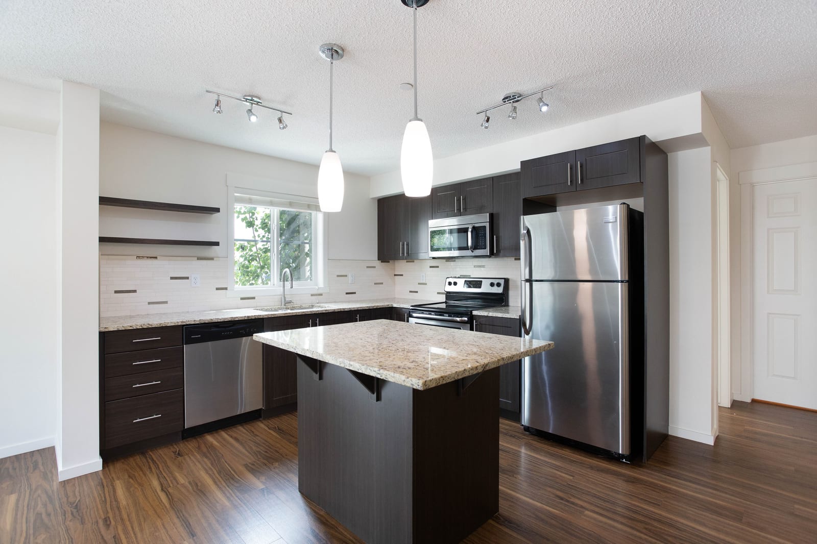 Granite island kitchen with stainless steel appliances