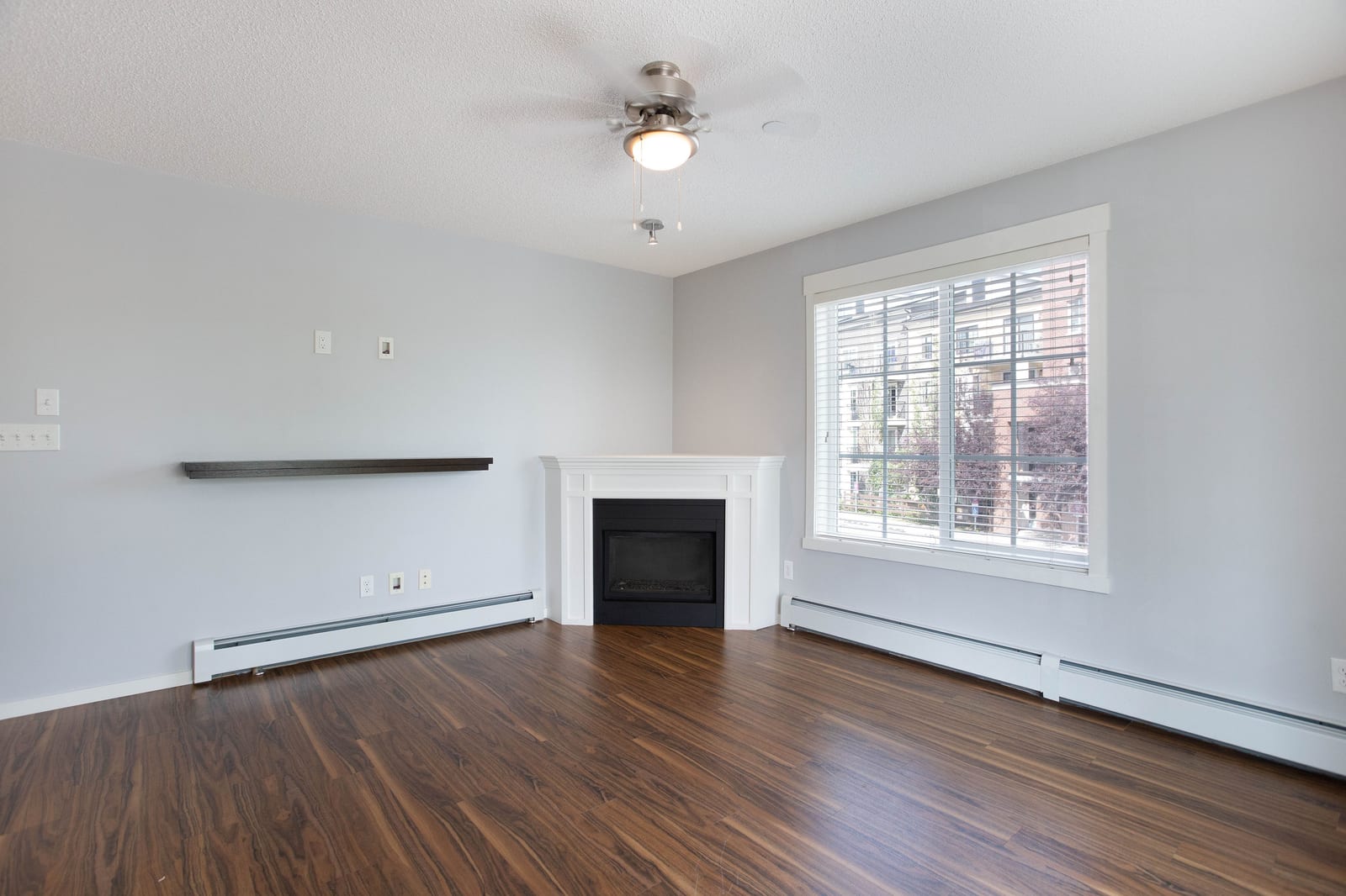 Unfurnished living room and corner fireplace