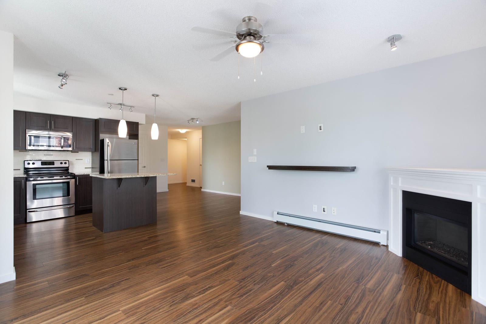 Unfurnished living room facing the kitchen