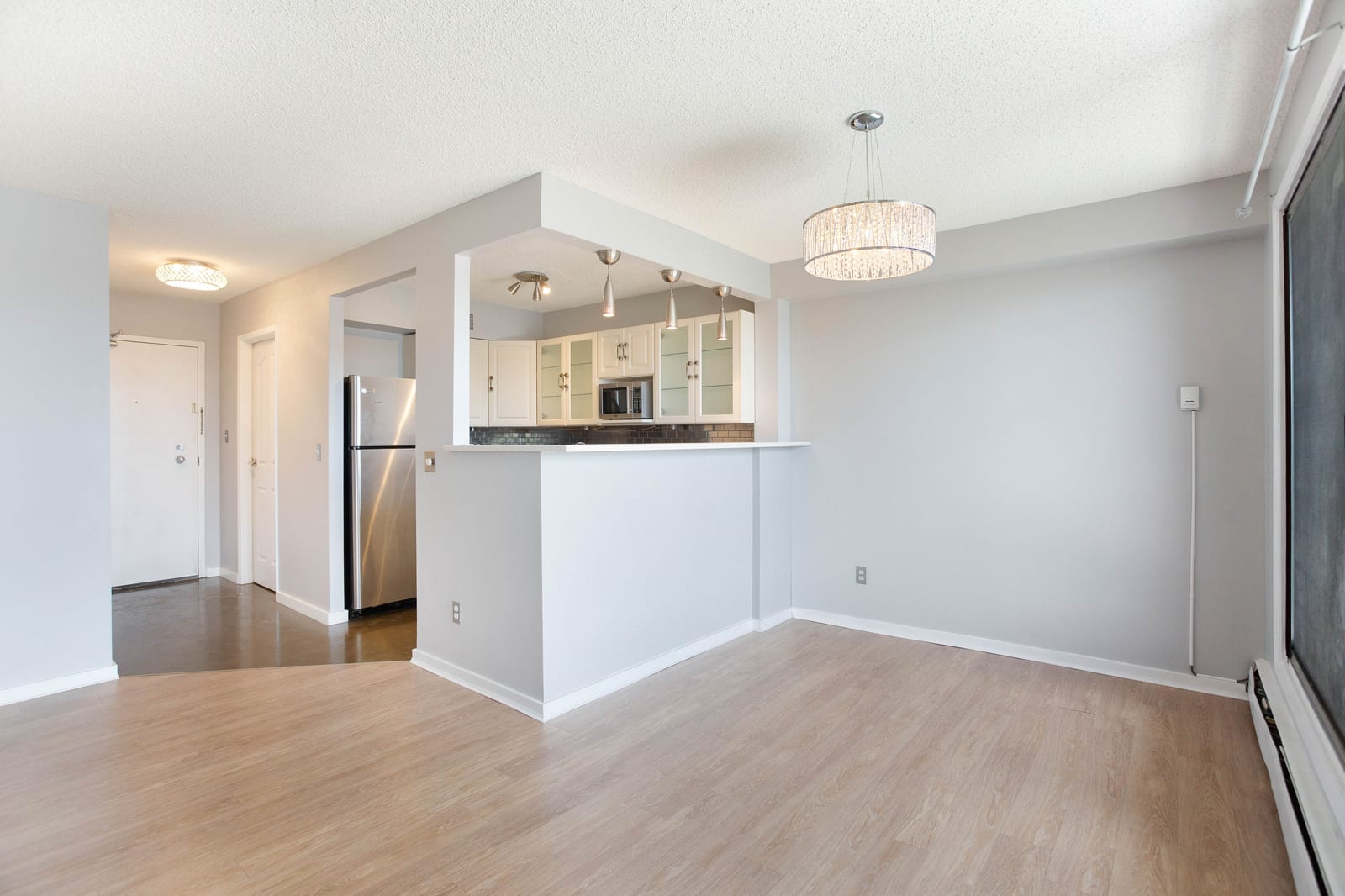 Unfurnished dining area beside balcony doors