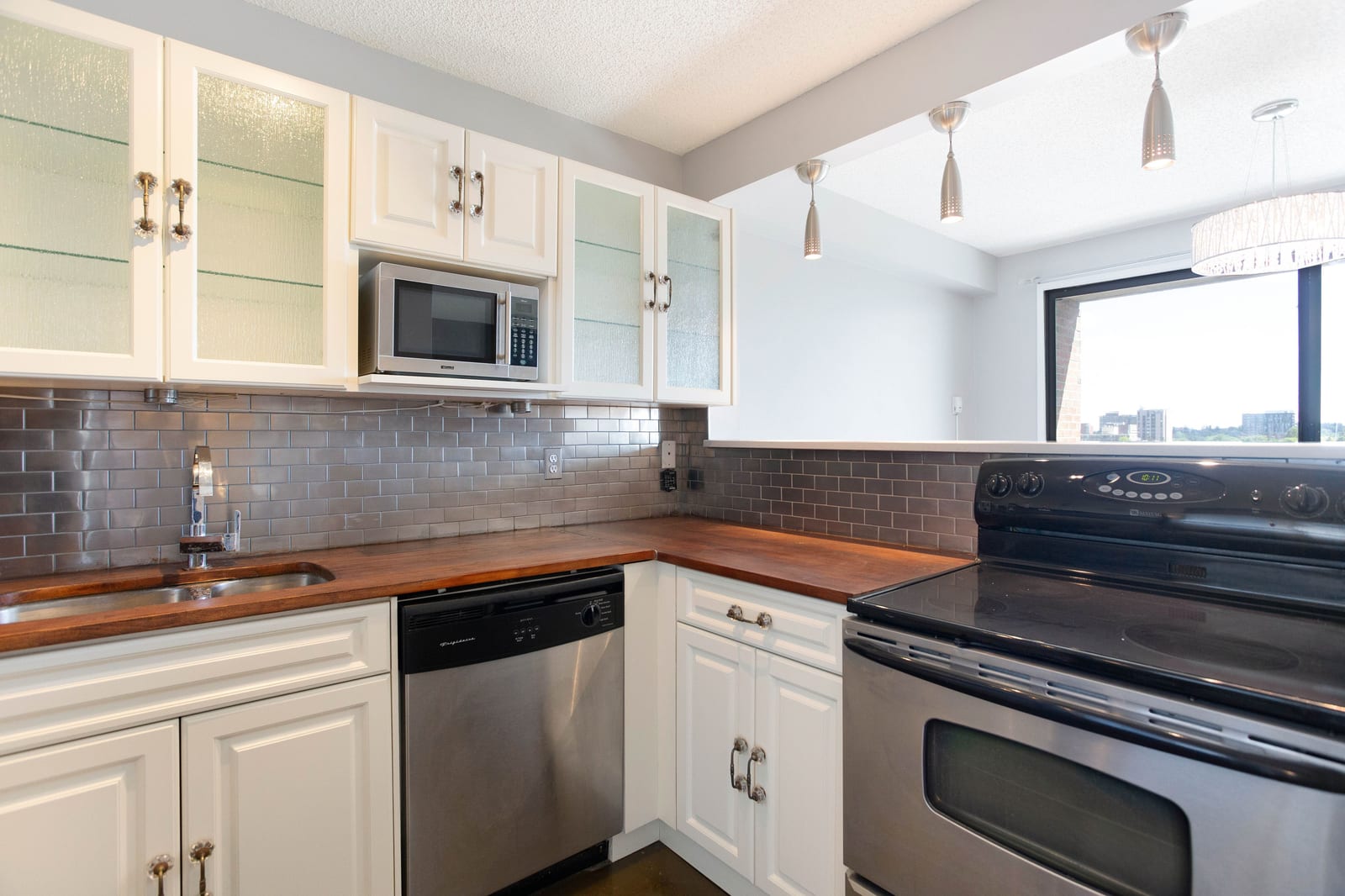 White kitchen cabinetry and wood counters