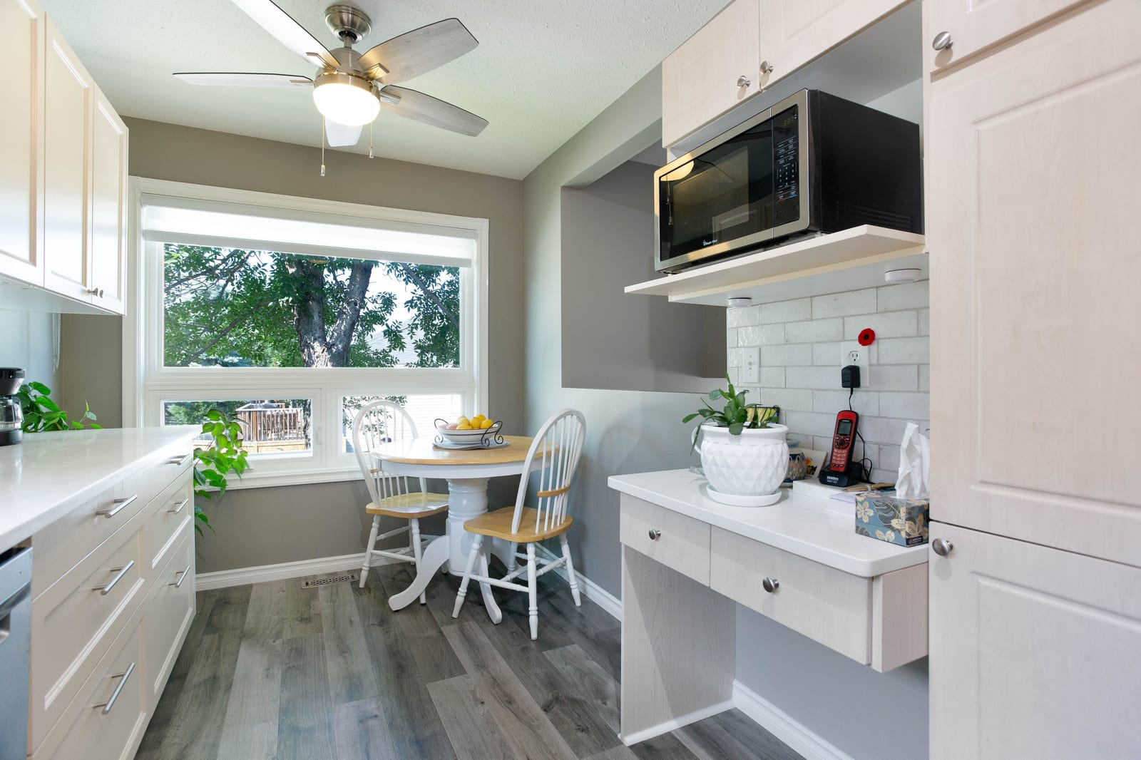 White cabinetry and window-side dining