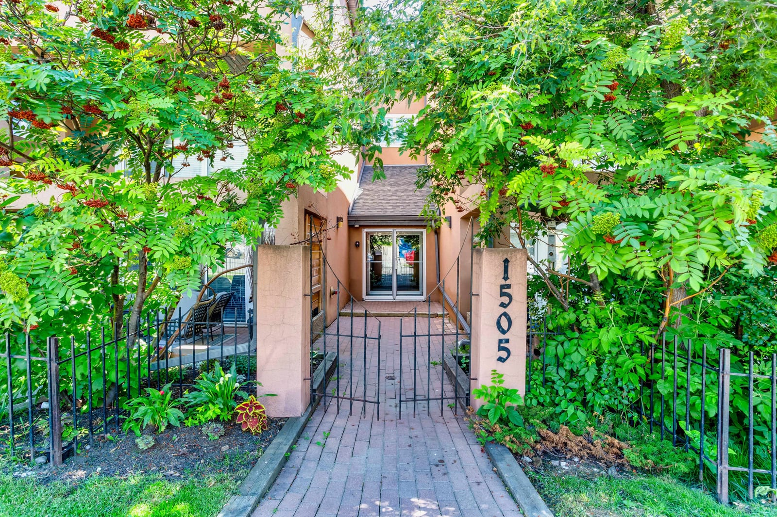 The landscaped street-side entrance