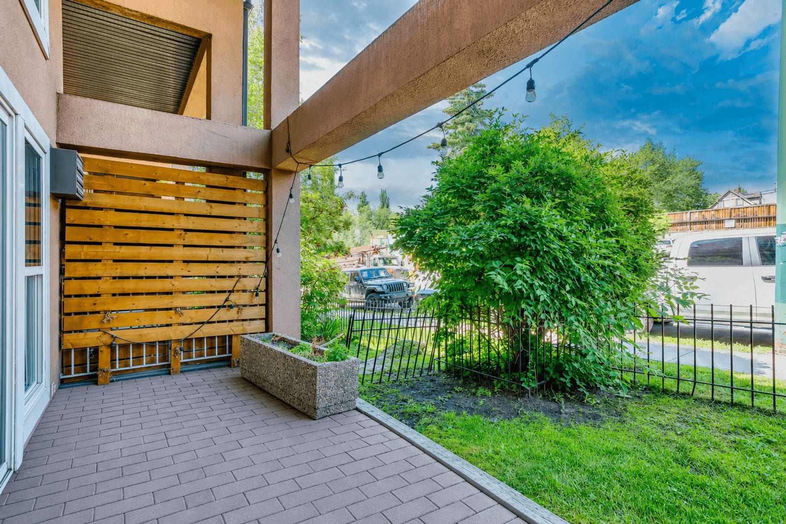 The ground-level patio and street-side setting