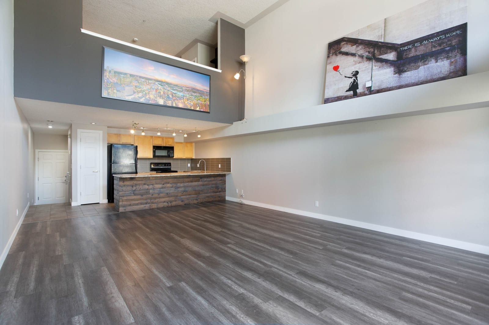 The unfurnished living room and loft above