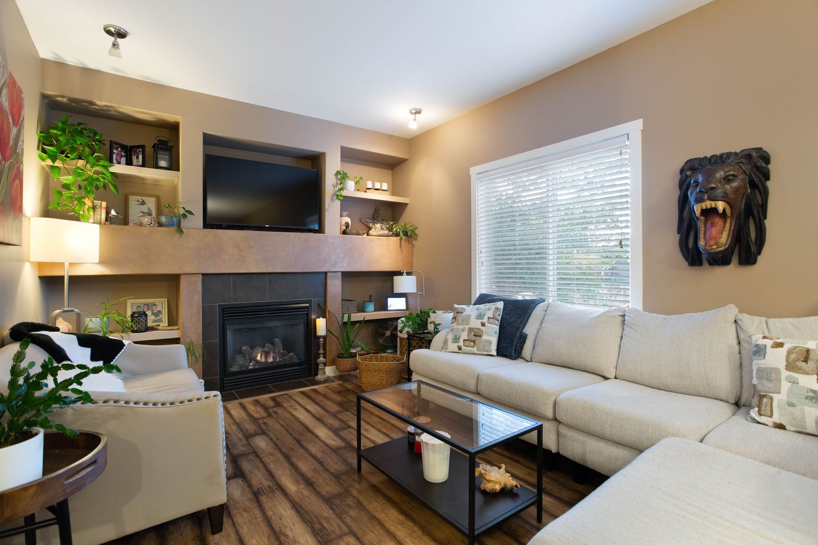 Living room with gas fireplace and built-in shelving — 317 Ranch Ridge Meadow N, Strathmore