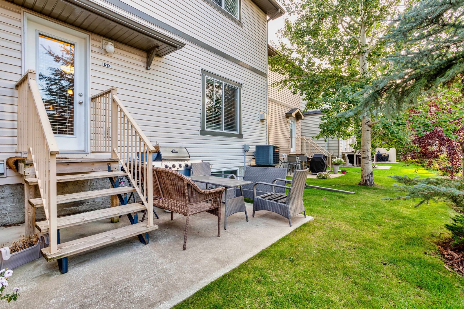 Rear patio and lawn — 317 Ranch Ridge Meadow N, Strathmore