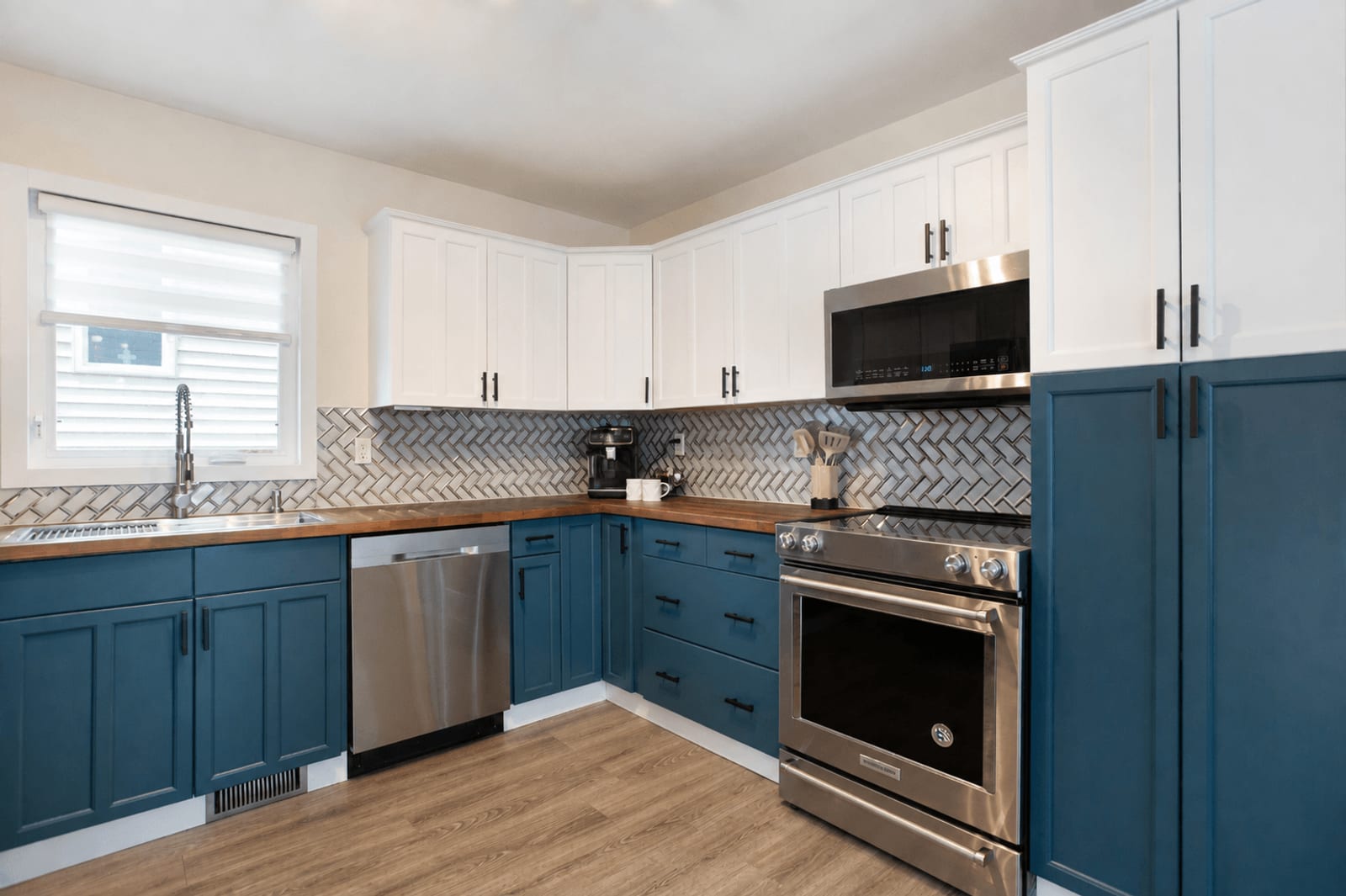 Blue lower cabinetry and white upper cabinets
