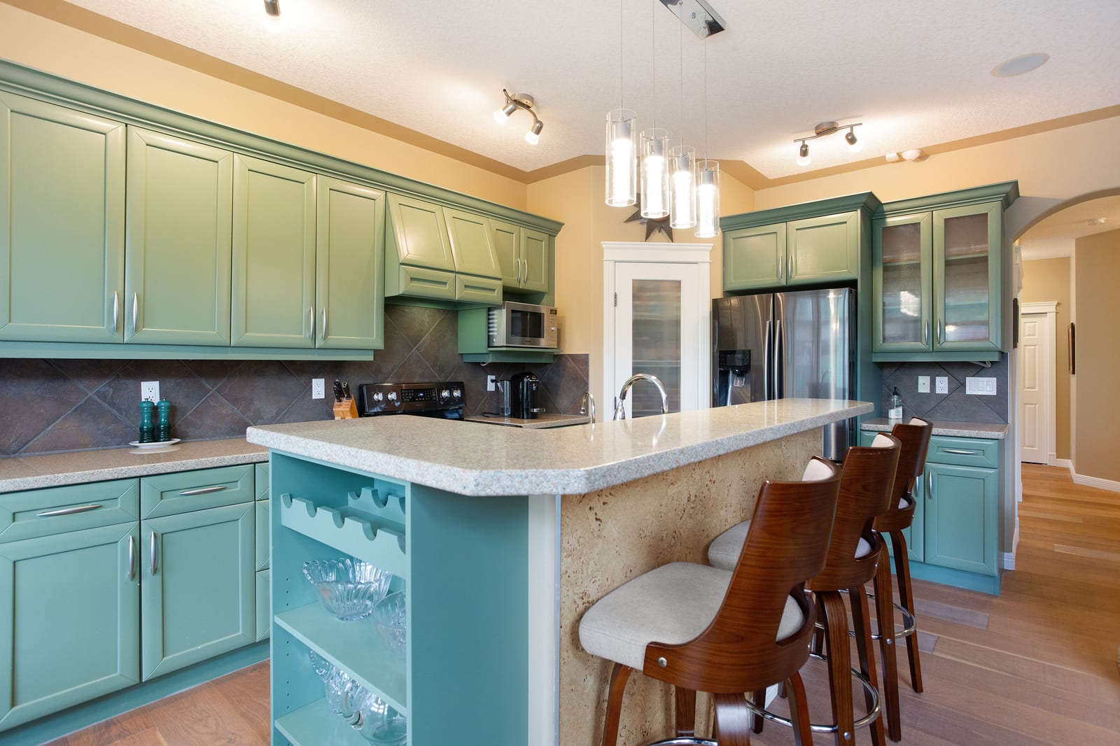 Green kitchen cabinetry and island