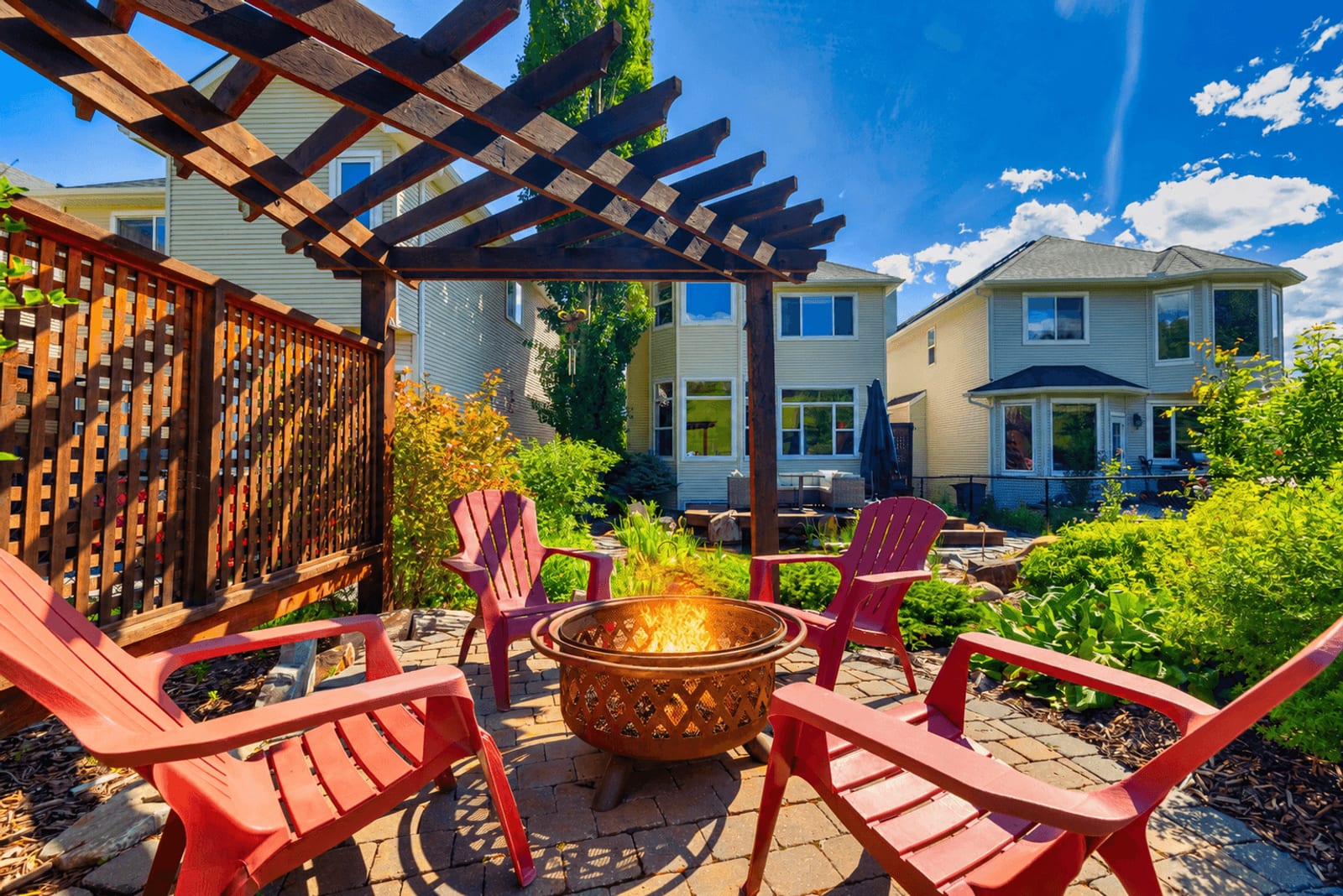 Stone patio with pergola and landscaped garden