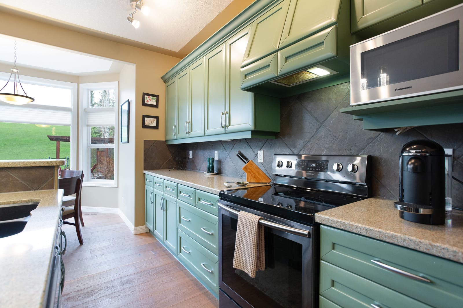 Cooking area and green cabinetry