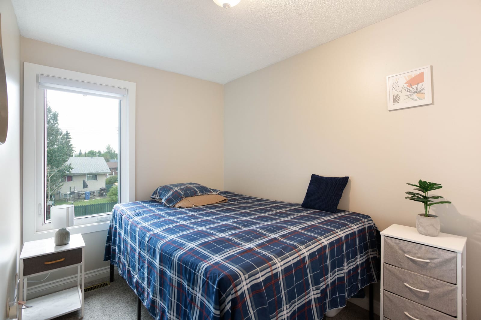 Bedroom with blue plaid bedding