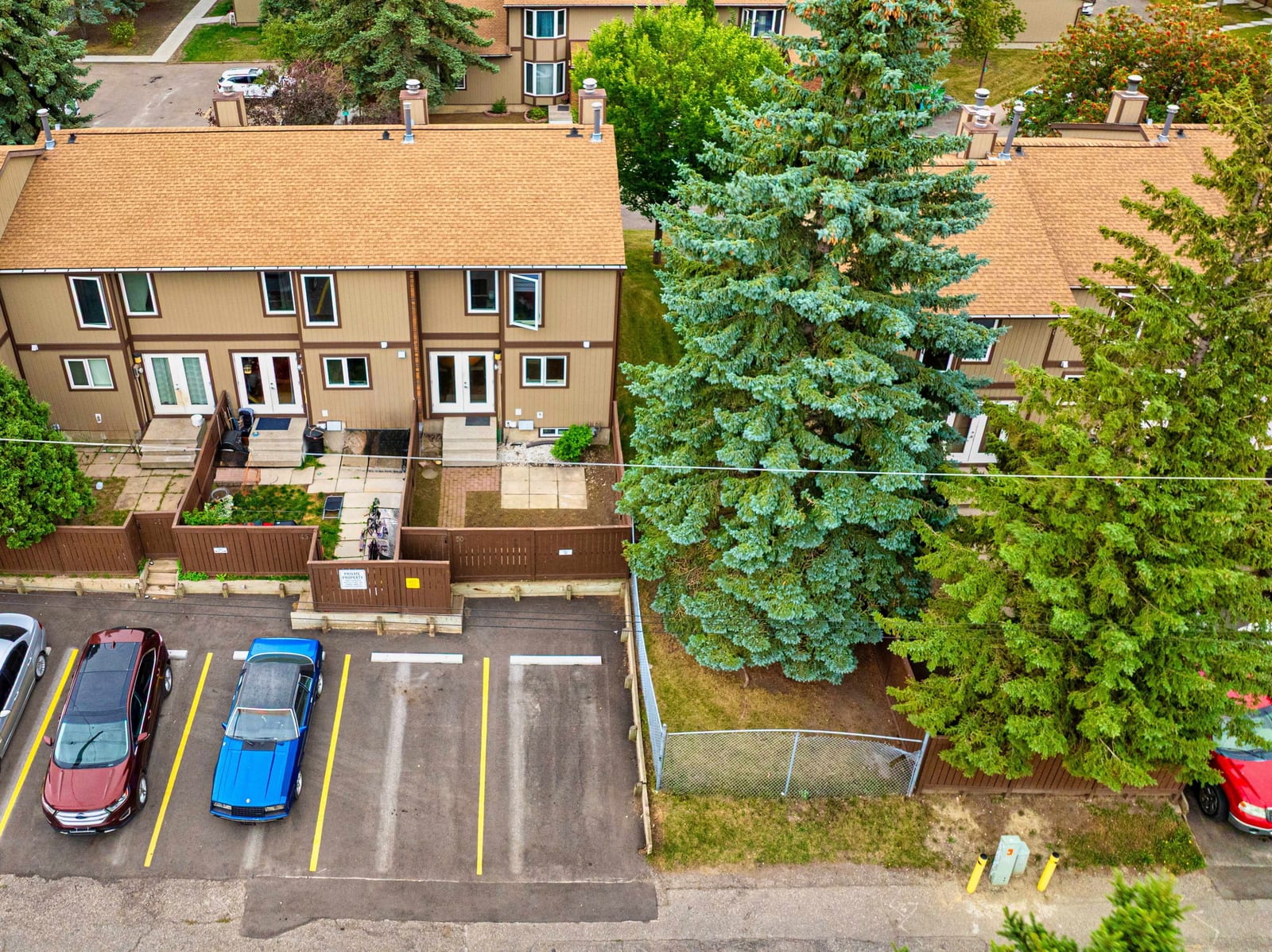 Aerial view of townhome row and mature trees
