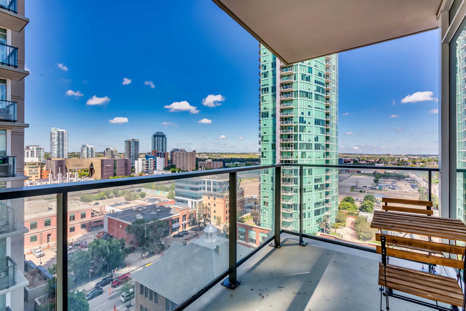Private balcony with glass railing and city outlook
