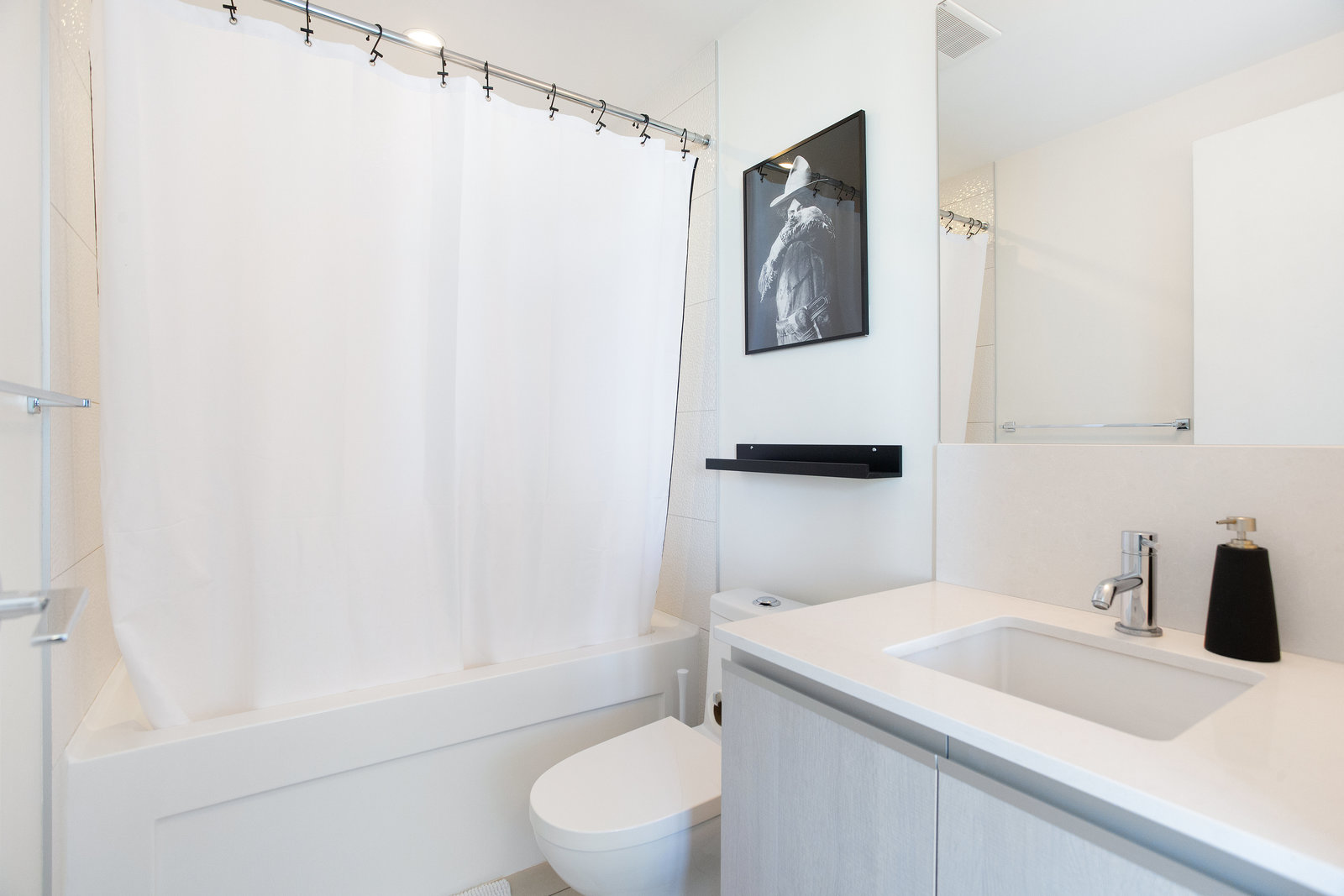 Bathroom with tub, vanity and shower curtain
