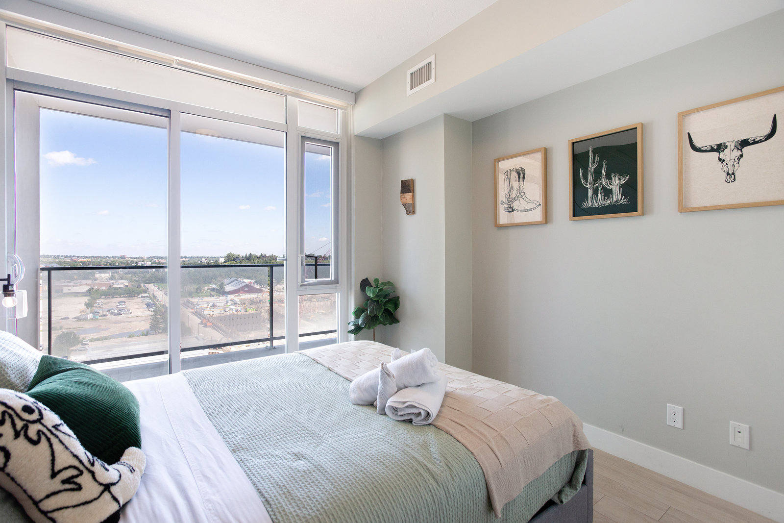 Bedroom with large window and balcony outlook