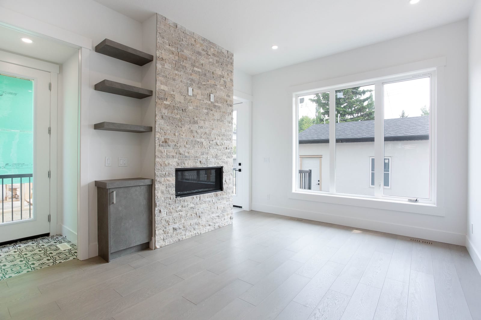 Unfurnished living room with stone fireplace — 1108 6 Street NE, Renfrew