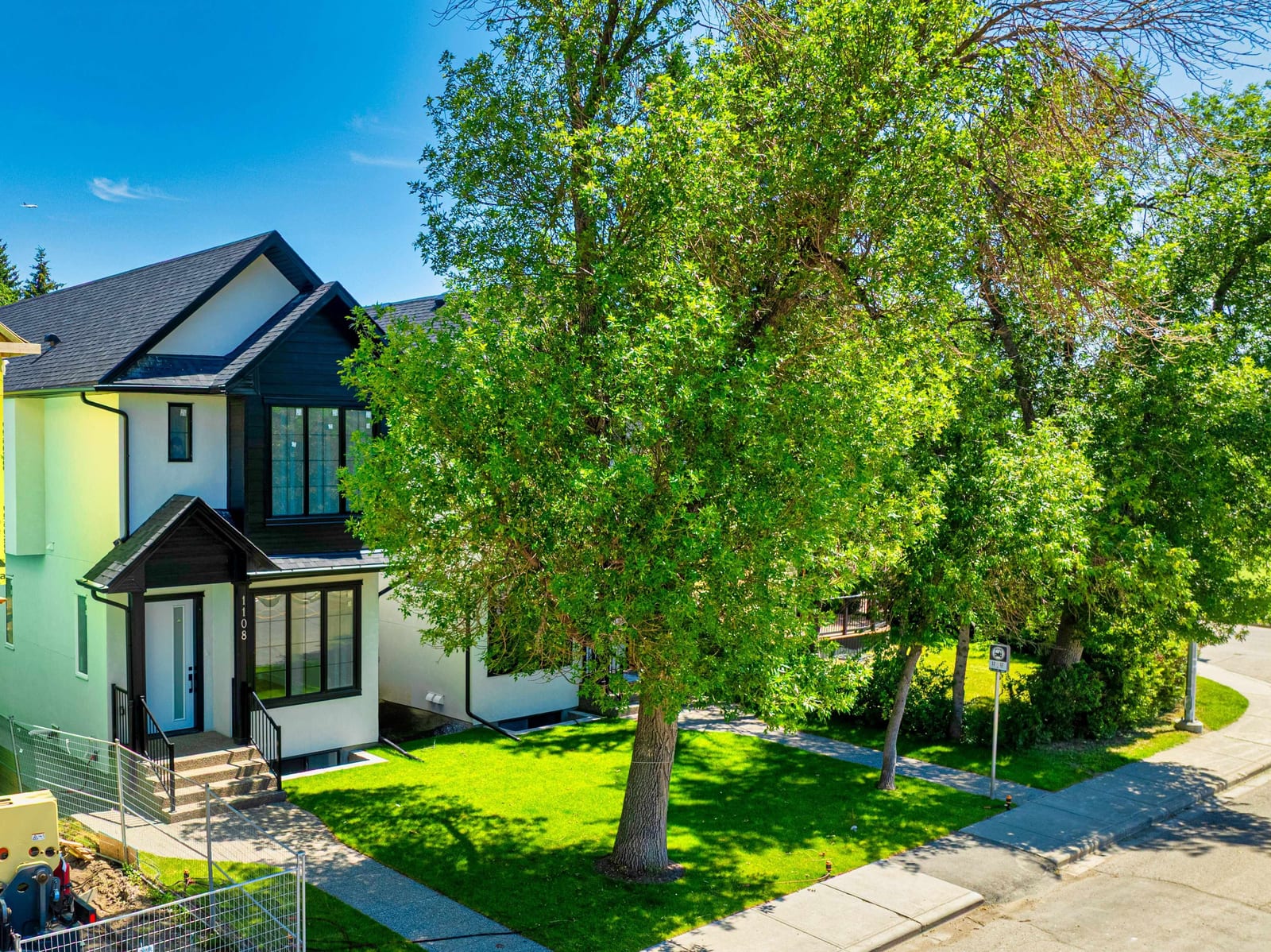 Elevated exterior view of the paired Renfrew homes — 1108 6 Street NE, Renfrew