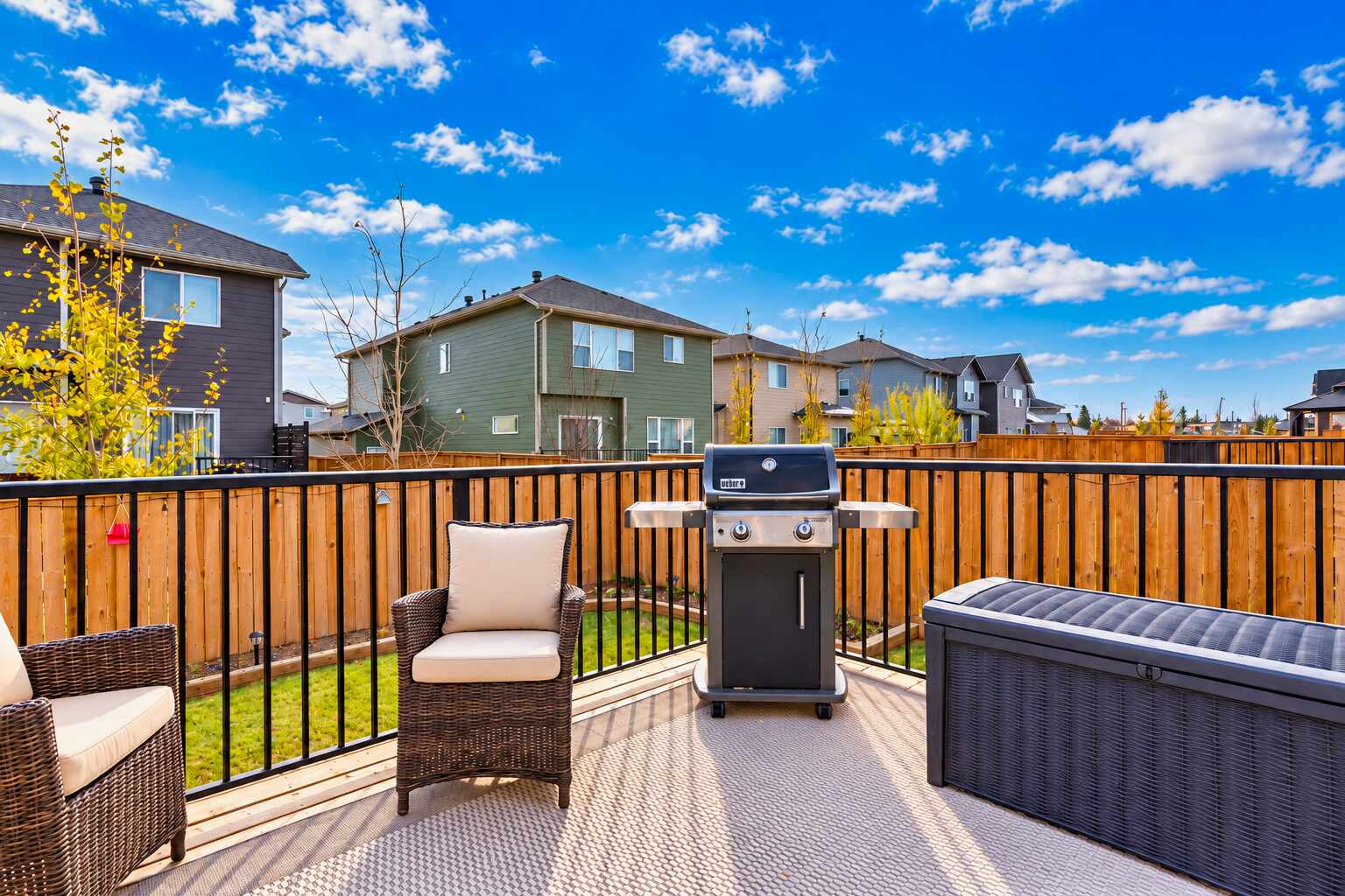 Rear deck with BBQ and patio seating — 809 Mandalay Link