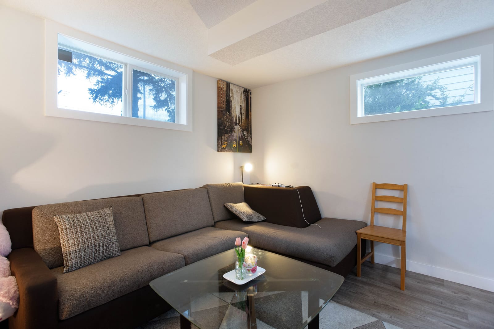 Lower-level living room with windows