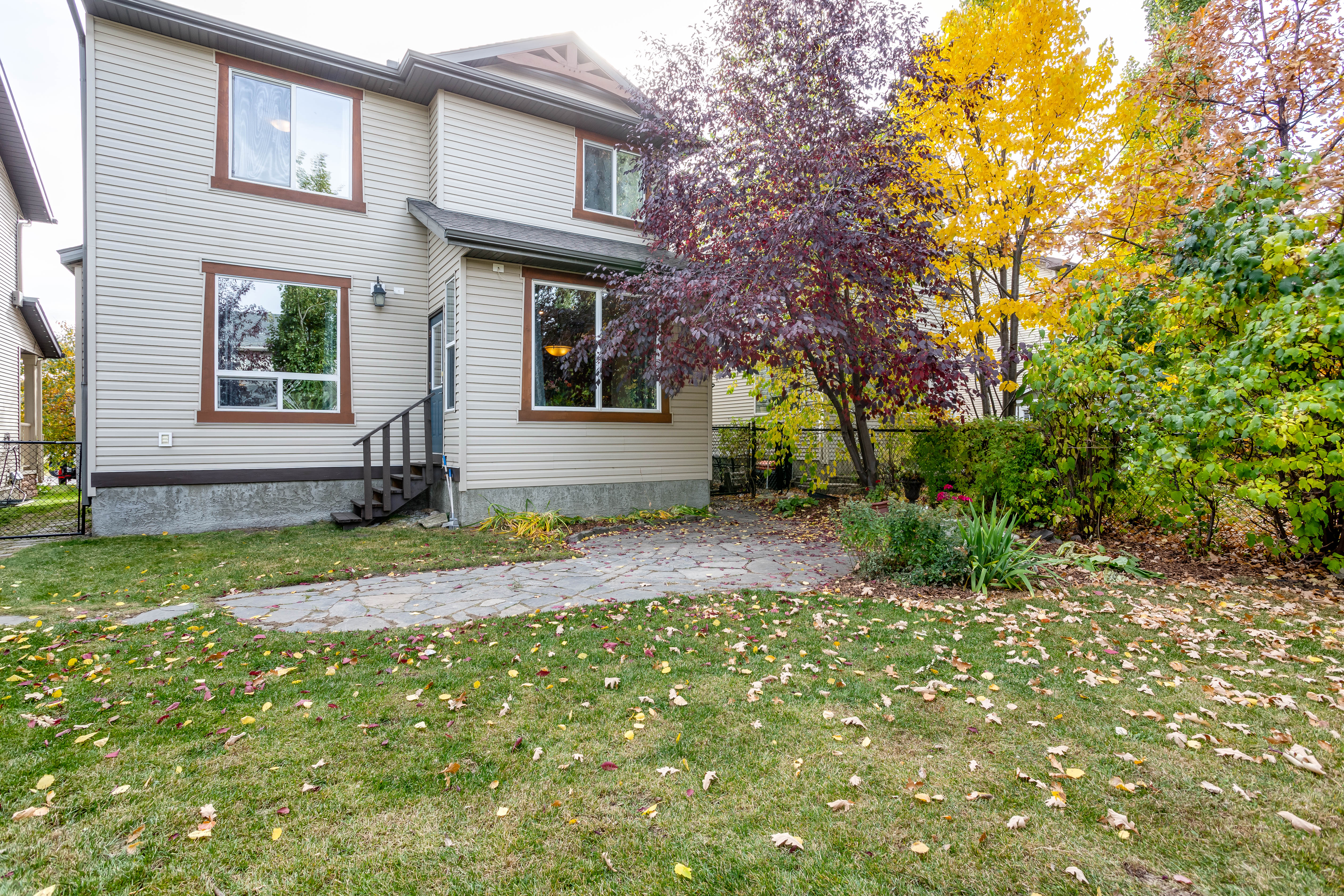 Private treed backyard — 66 Cougarstone Close SW, Calgary
