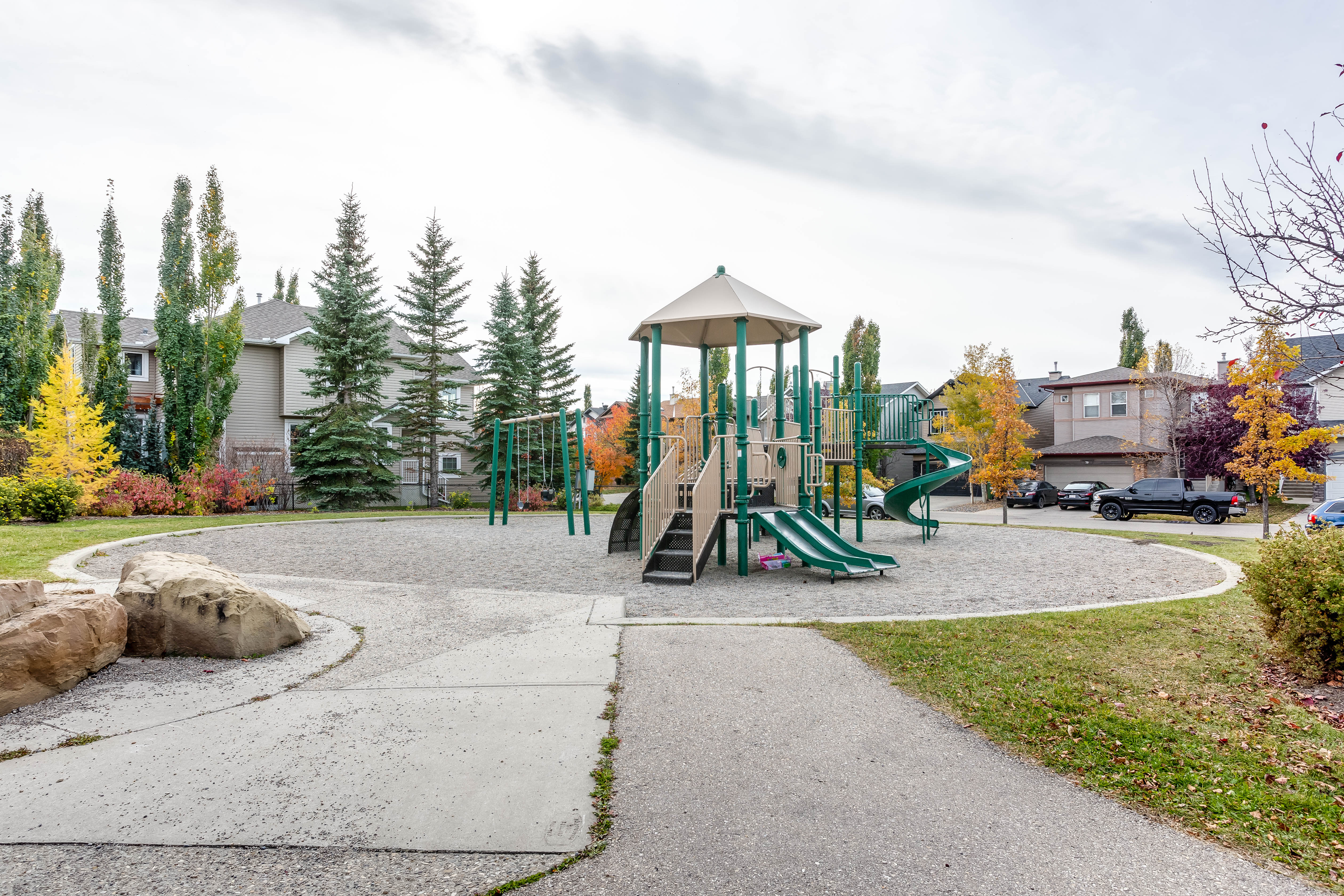 Green space and playground opposite the home — 66 Cougarstone Close SW, Calgary