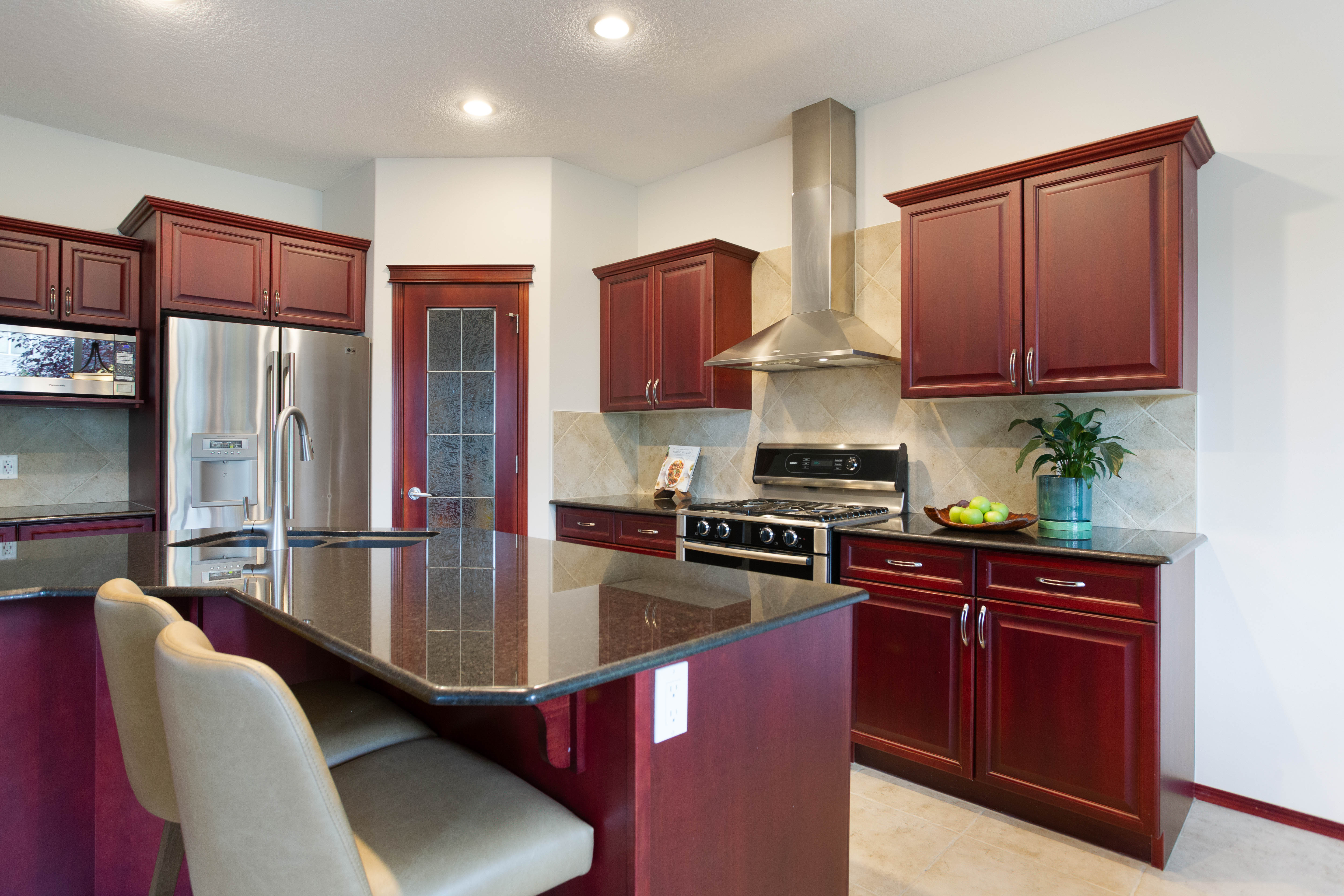 Kitchen cabinetry and stone counters — 66 Cougarstone Close SW, Calgary