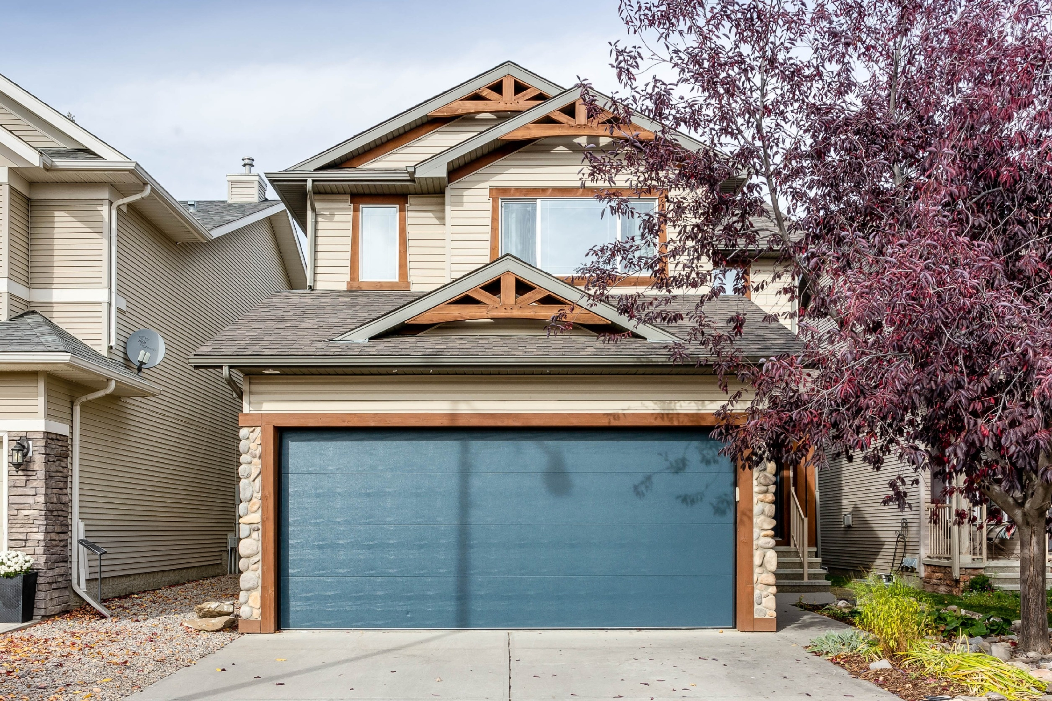 Front elevation and attached garage — 66 Cougarstone Close SW, Calgary