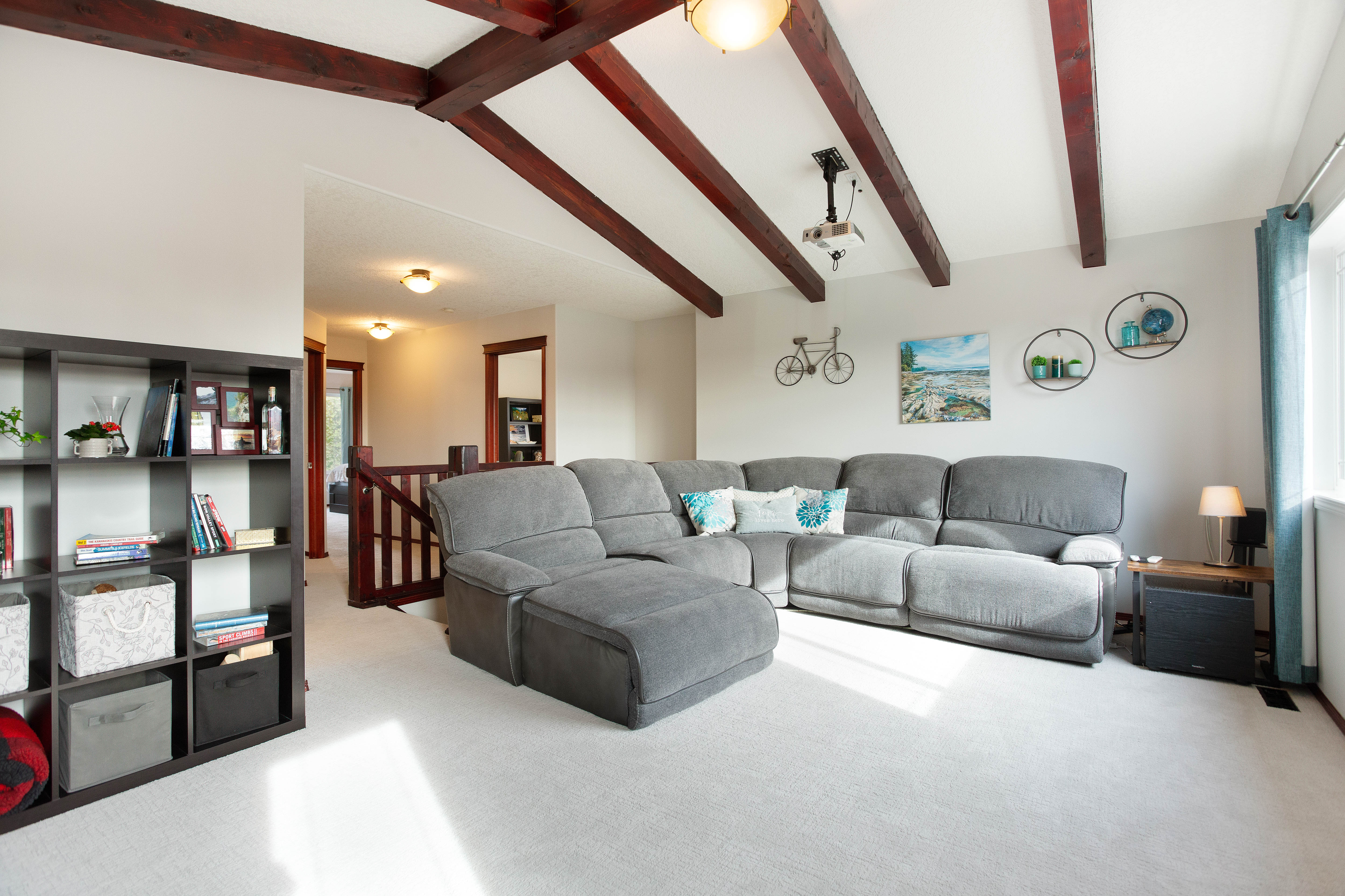 Bonus room with exposed wood beams — 66 Cougarstone Close SW, Calgary