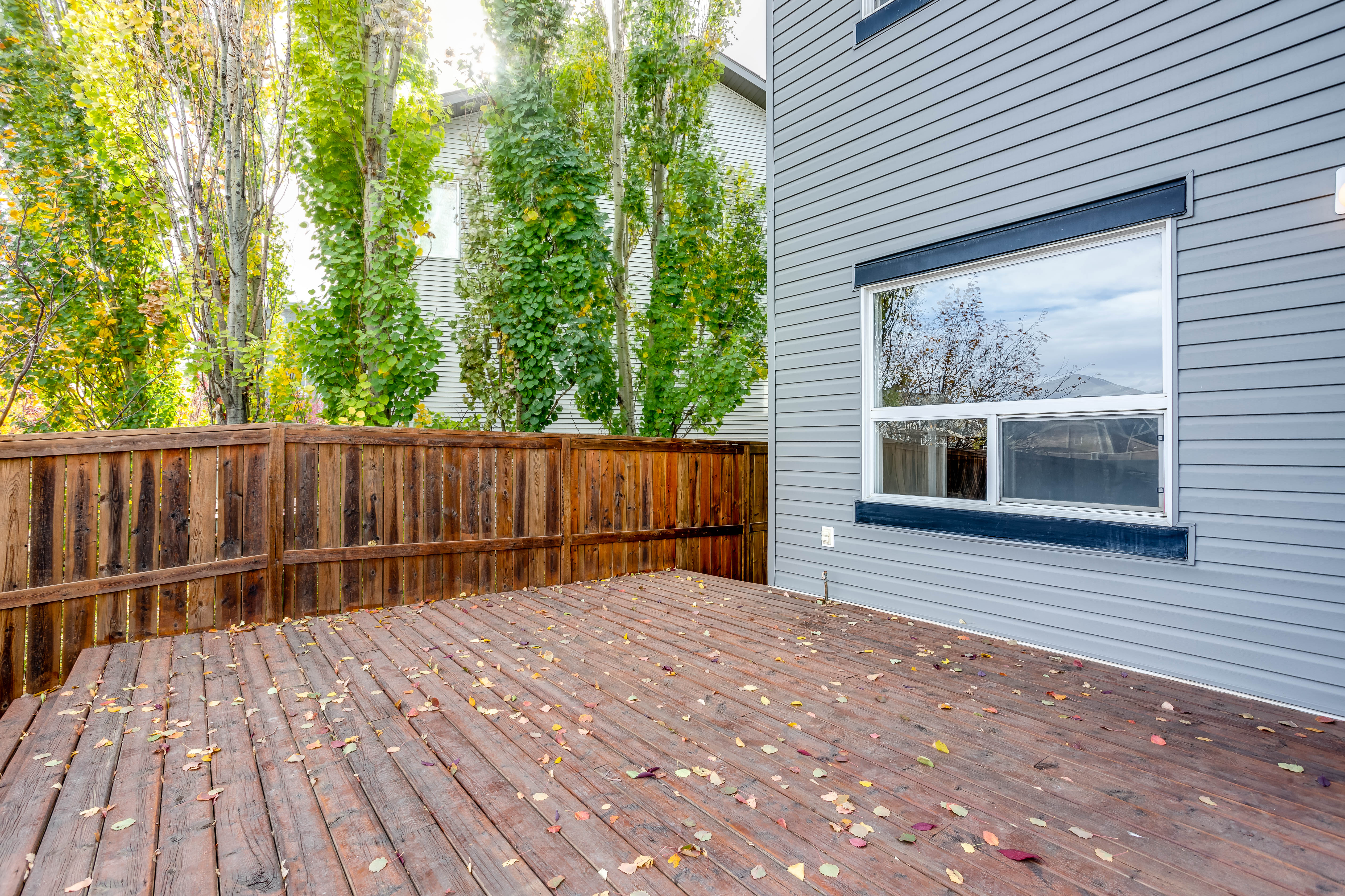 Deck and neighbouring trees — 119 Sage Hill Green NW