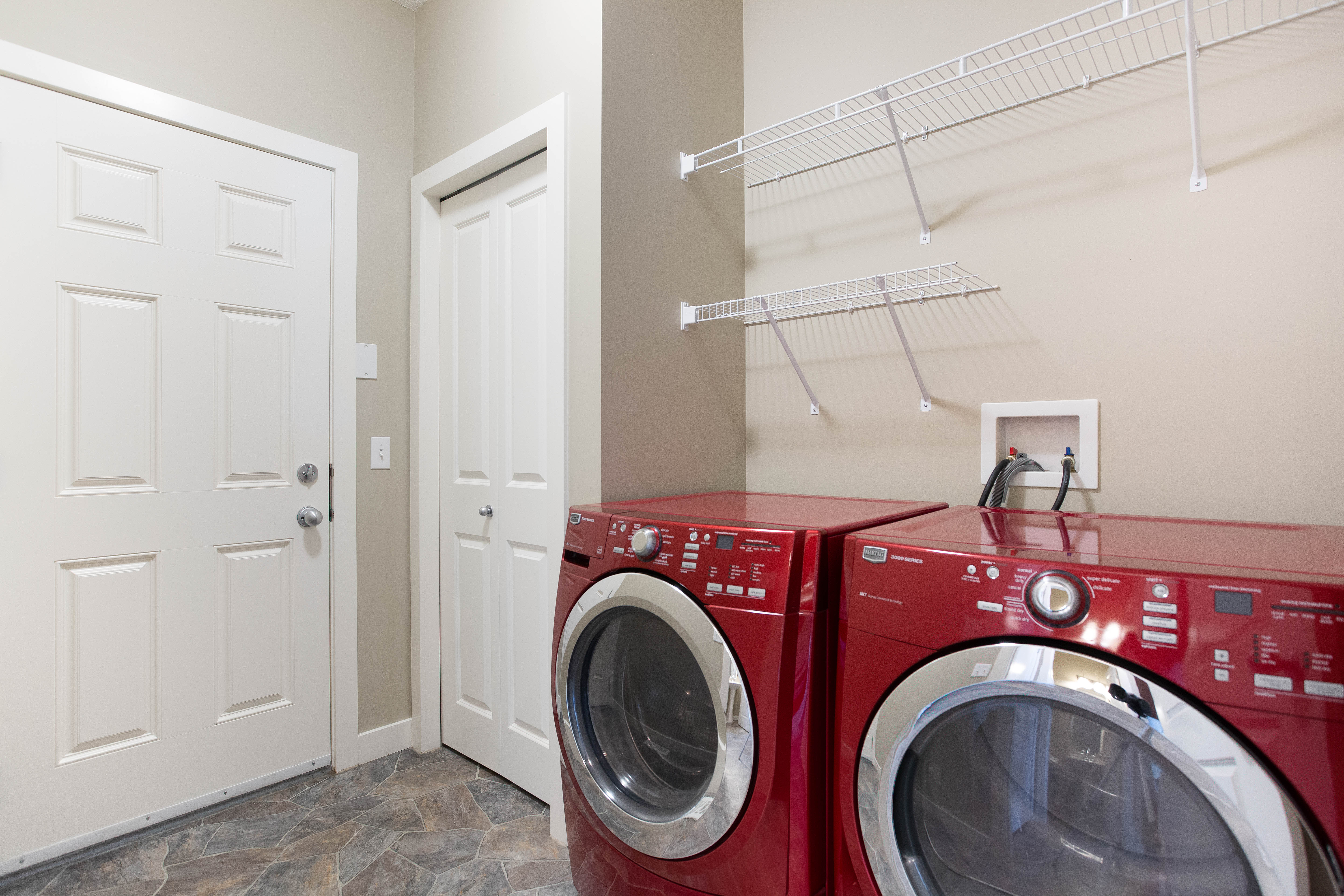 Main-floor laundry and mudroom — 119 Sage Hill Green NW