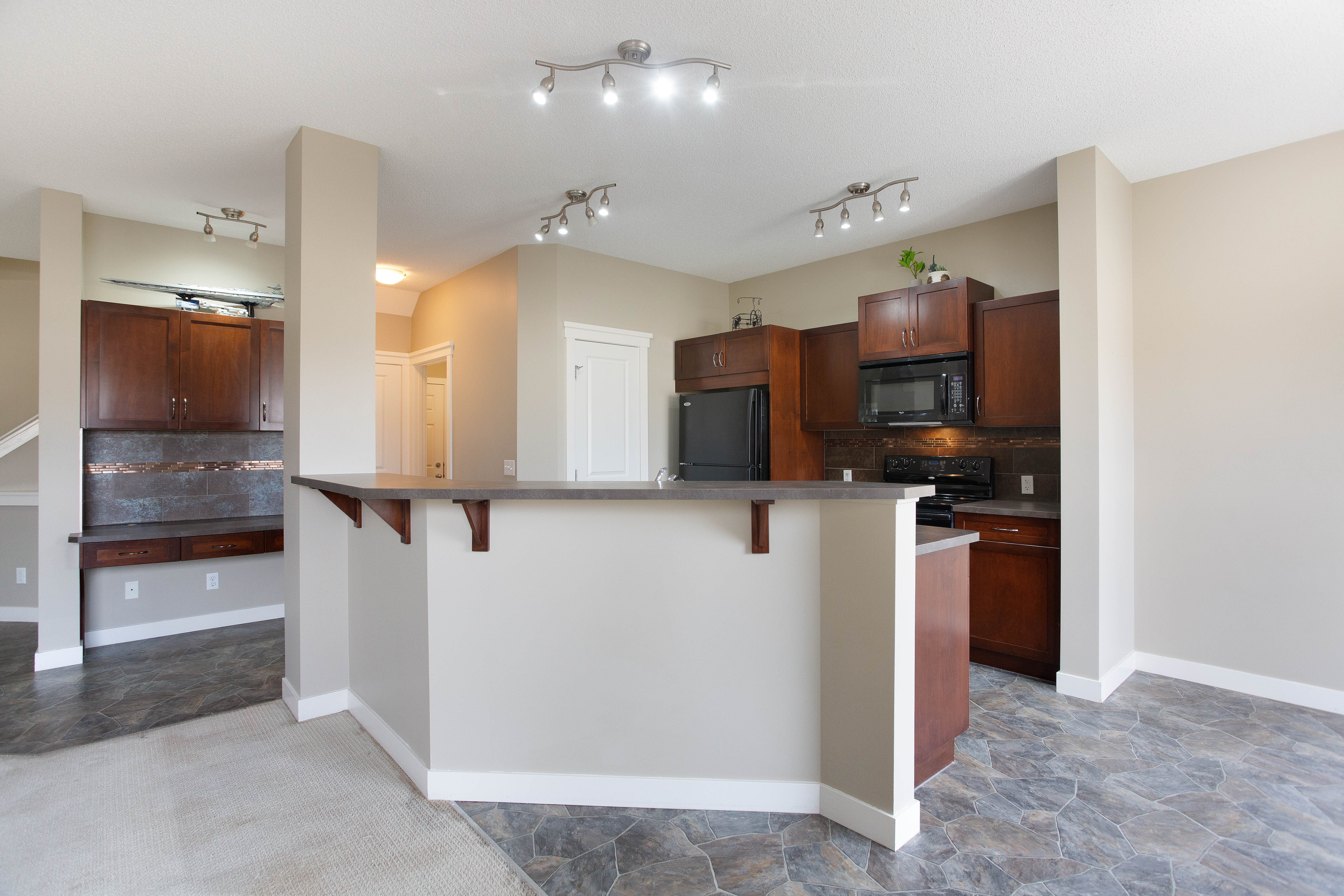 Kitchen peninsula and cabinetry — 119 Sage Hill Green NW