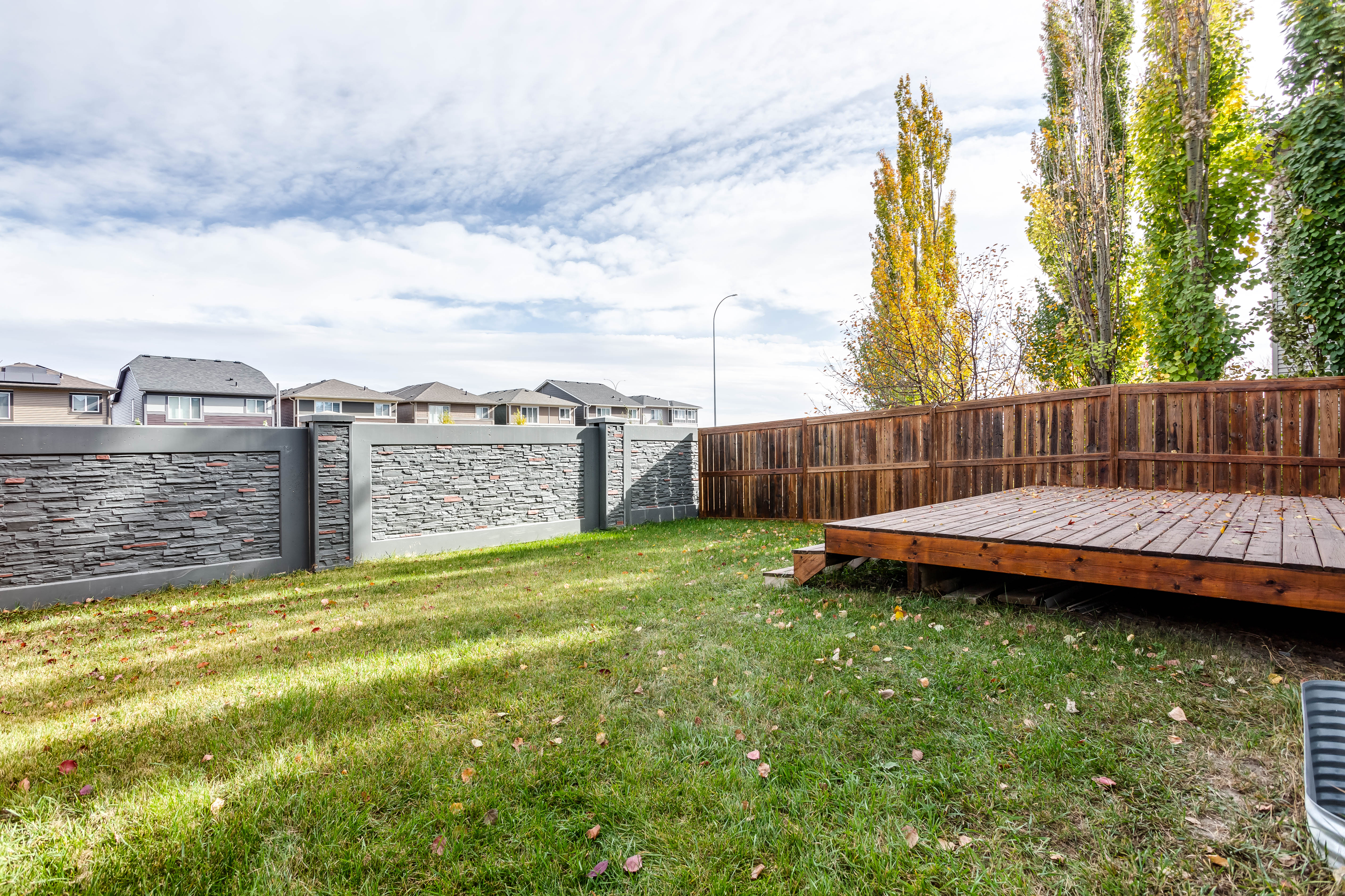 Fenced backyard and raised deck — 119 Sage Hill Green NW