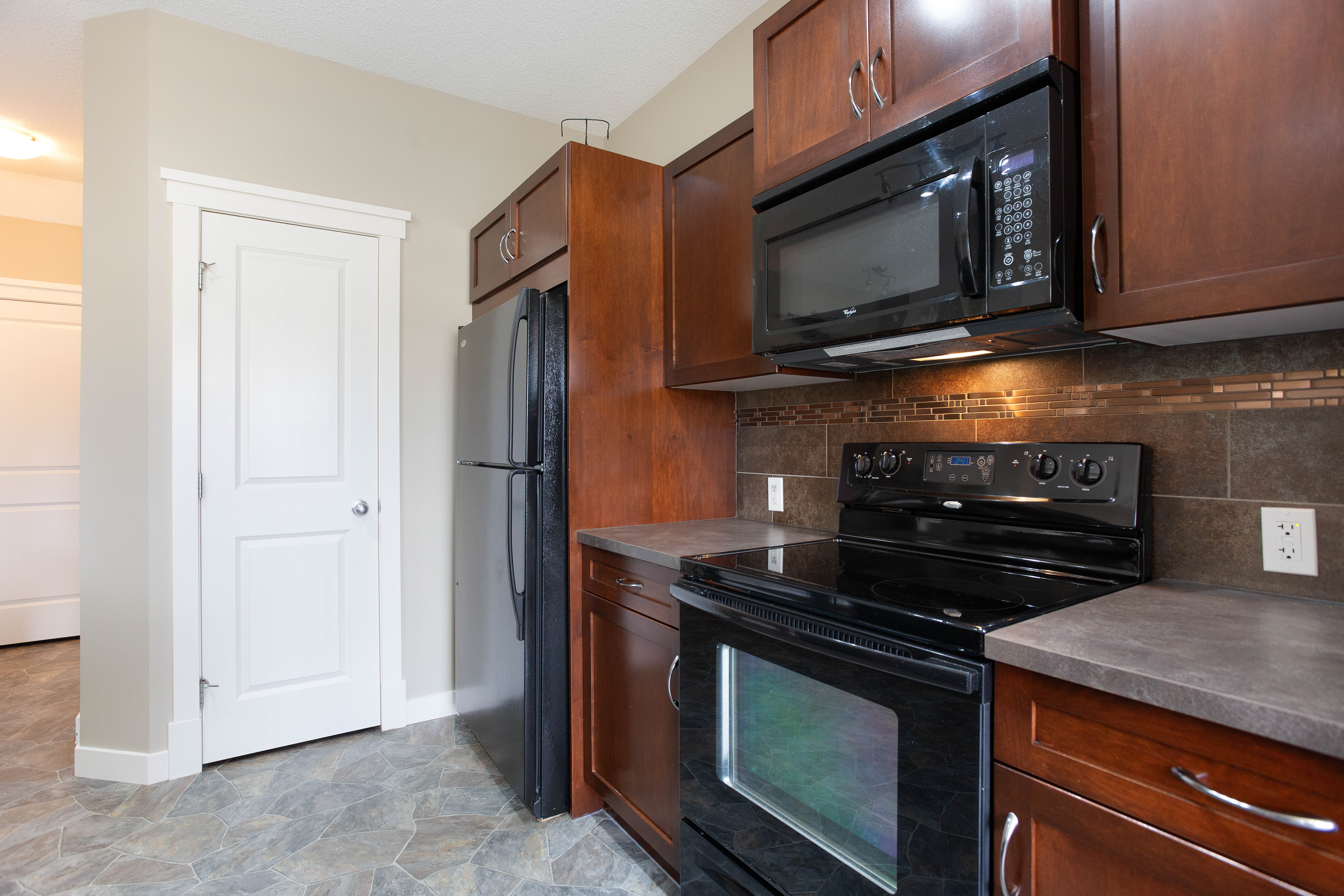 Range and cabinet storage — 119 Sage Hill Green NW