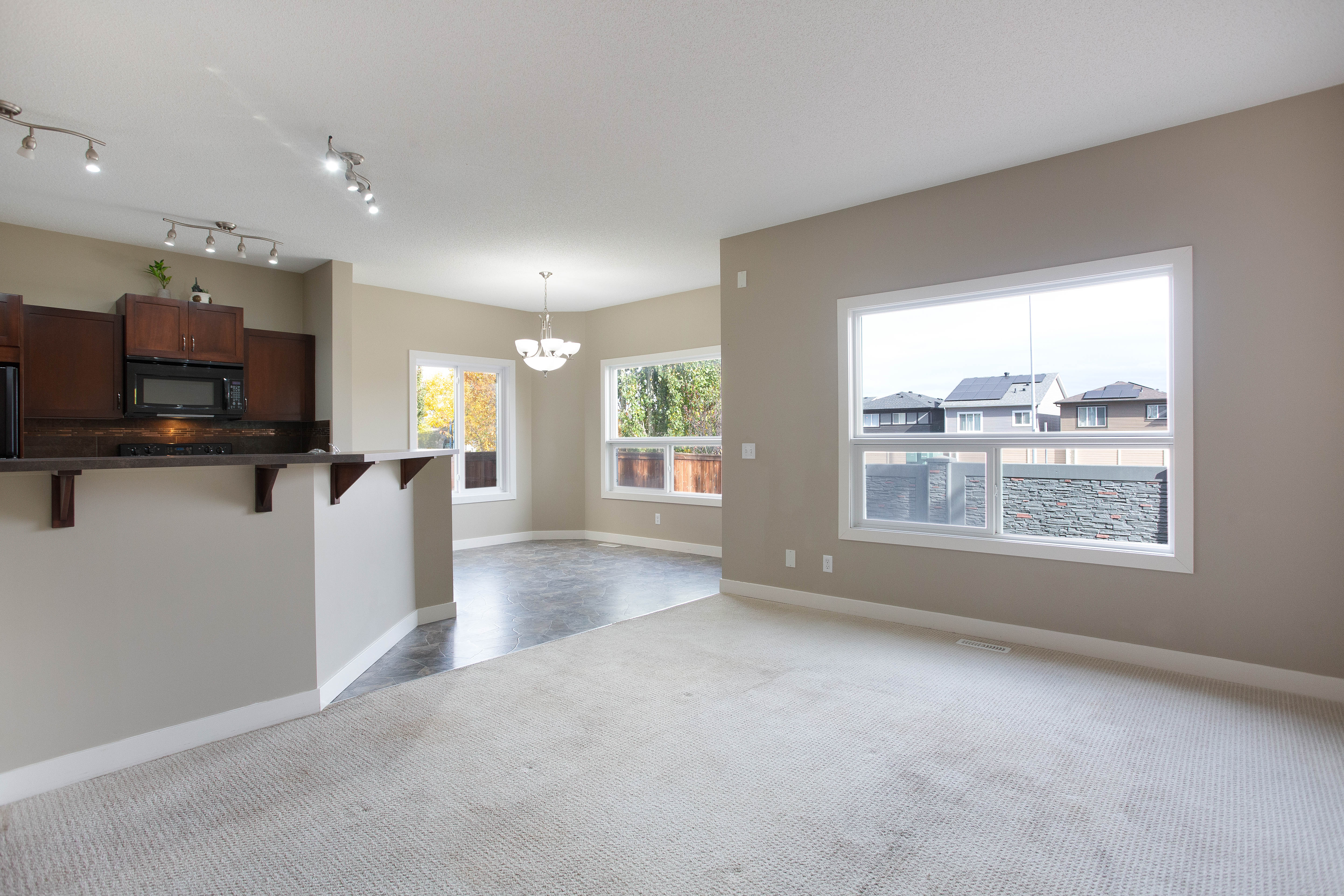 Living room connected to the kitchen — 119 Sage Hill Green NW