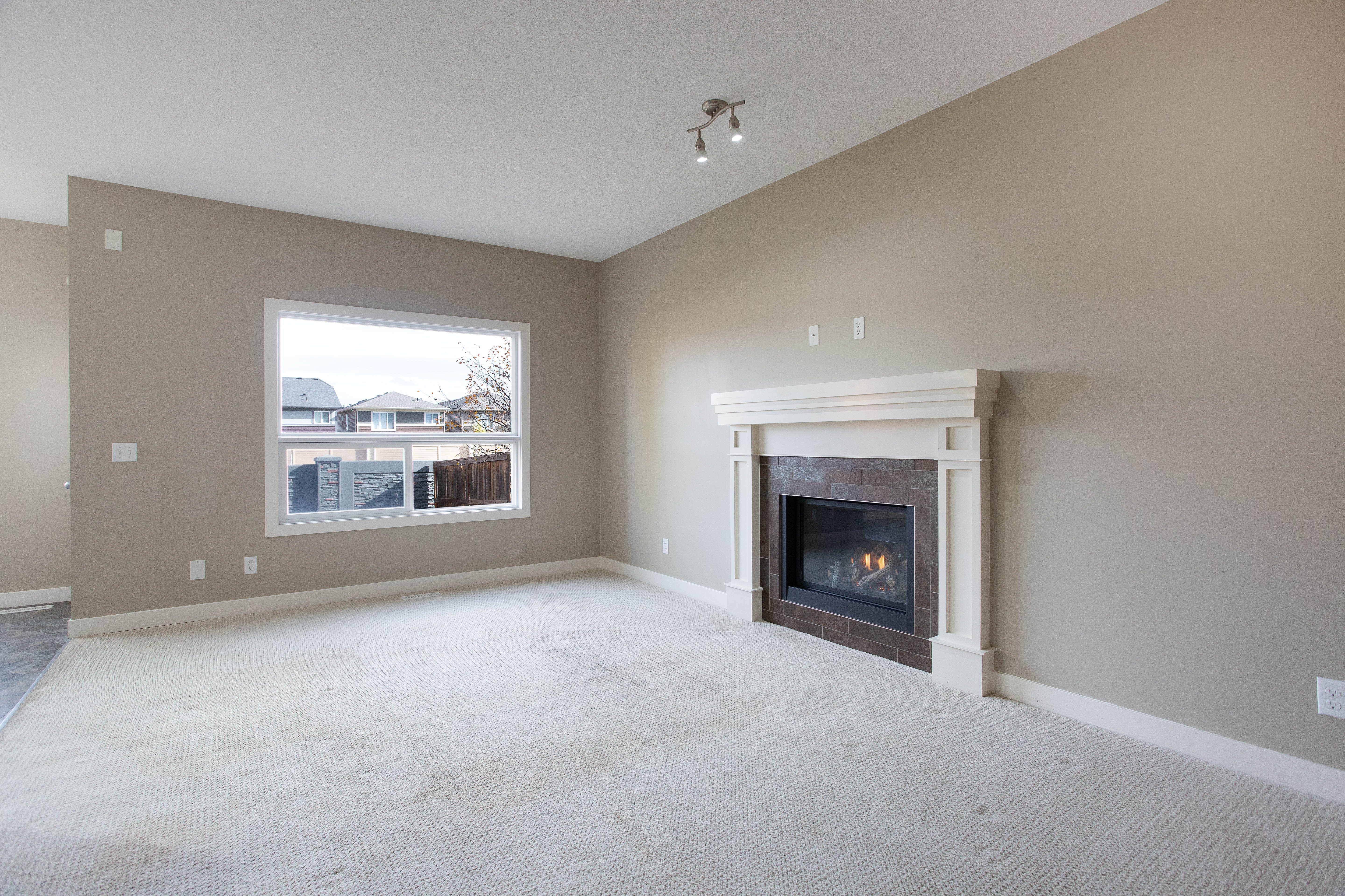 Living room with gas fireplace — 119 Sage Hill Green NW
