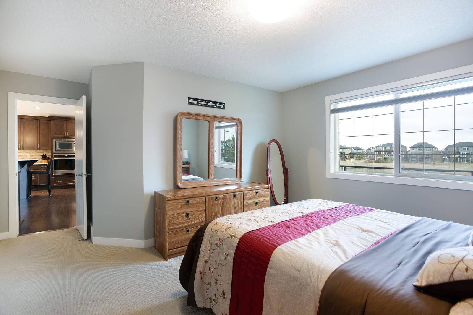 Bedroom with ensuite doorway and large window