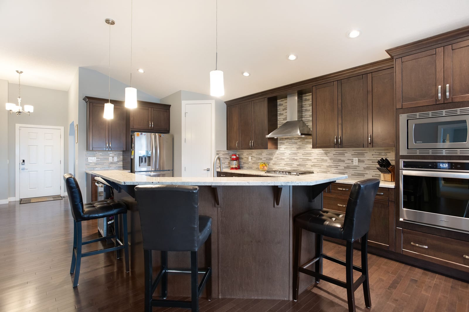 Kitchen island with seating and dining beyond