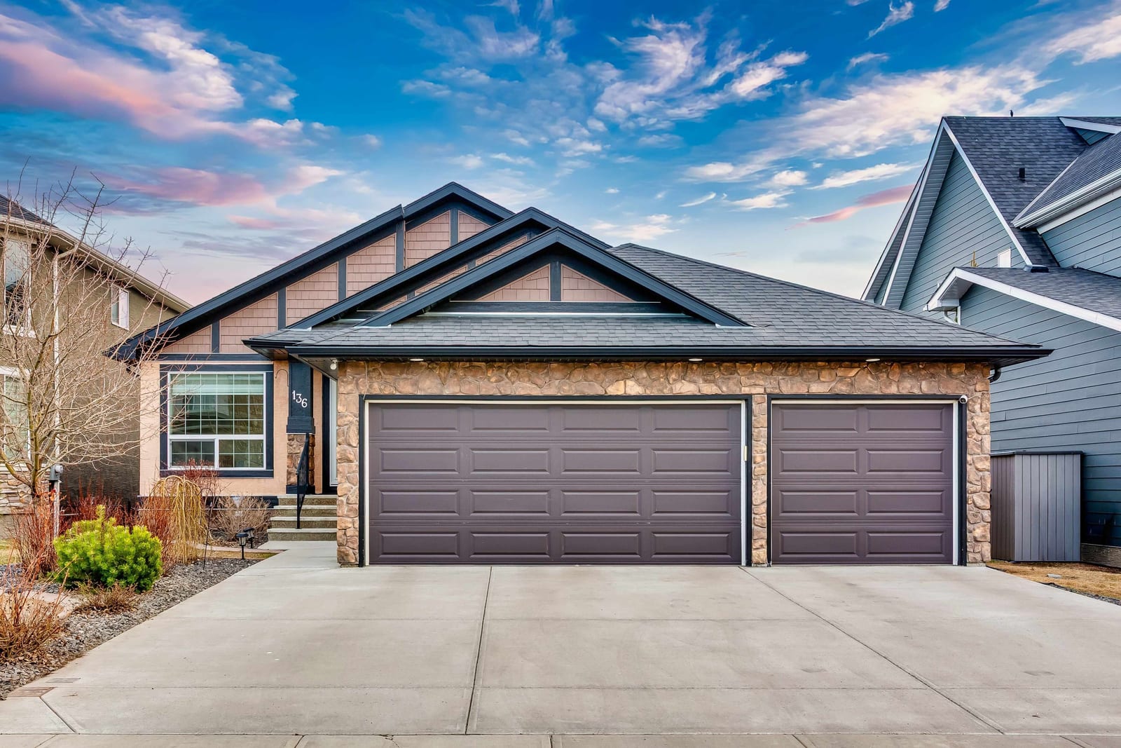 Front exterior with triple attached garage
