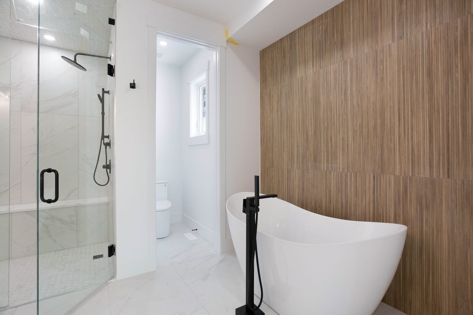 Ensuite shower and freestanding bathtub — supplied paired-home gallery; confirm 1106 finishes