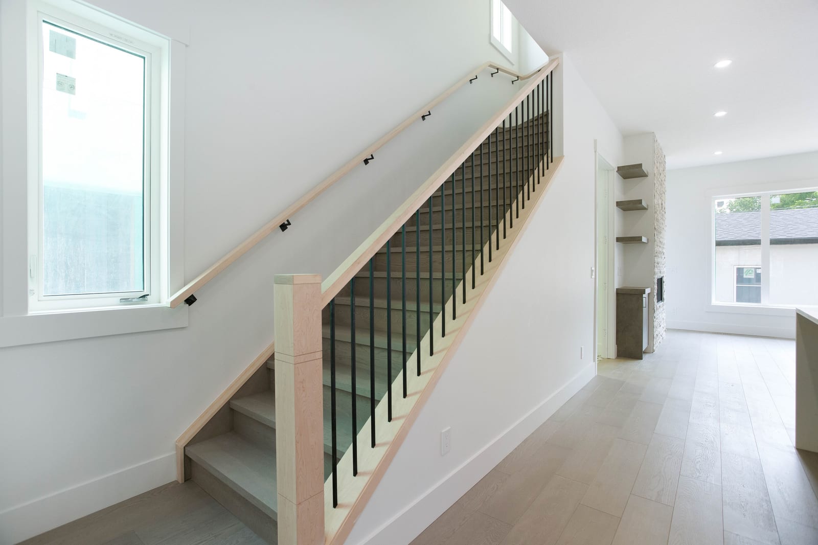Staircase and main-floor living connection — supplied paired-home gallery; confirm 1106 finishes