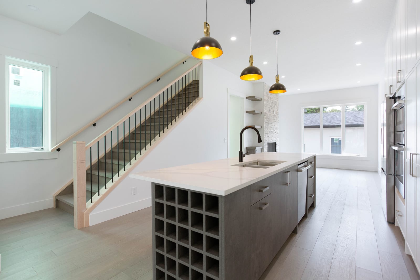 Kitchen island beside the open staircase — supplied paired-home gallery; confirm 1106 finishes