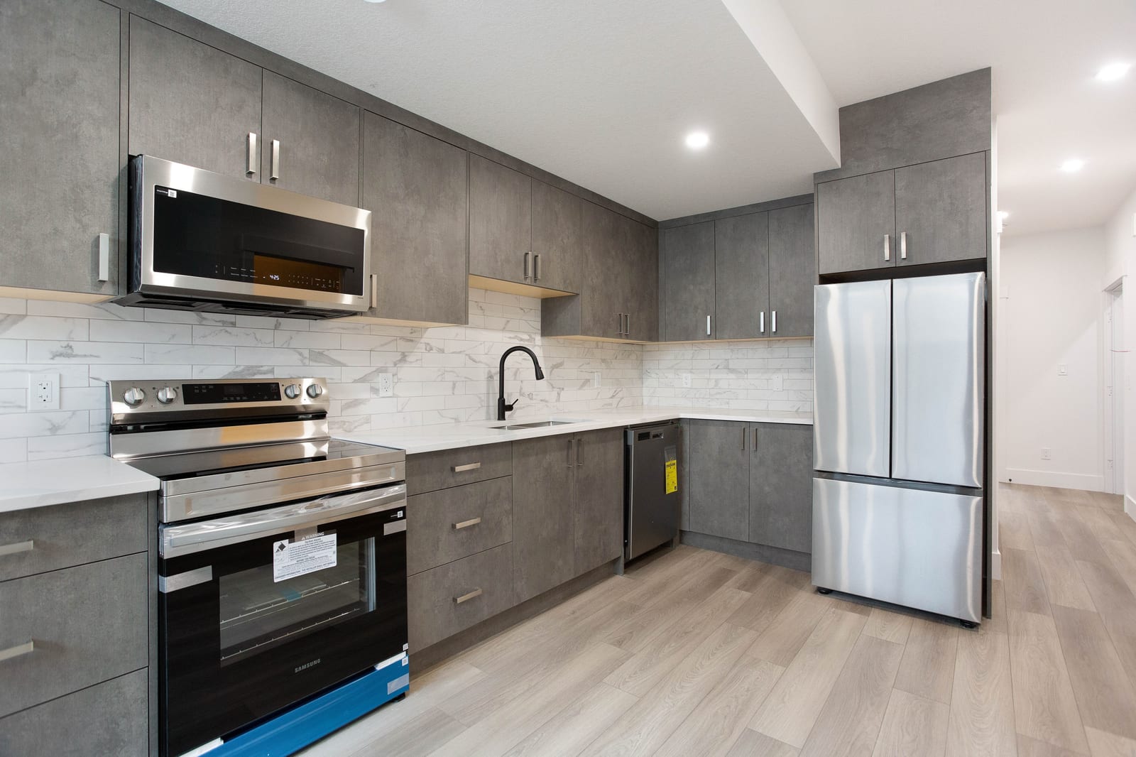 Lower-level kitchen cabinetry and cooking area — supplied paired-home gallery; confirm 1106 finishes