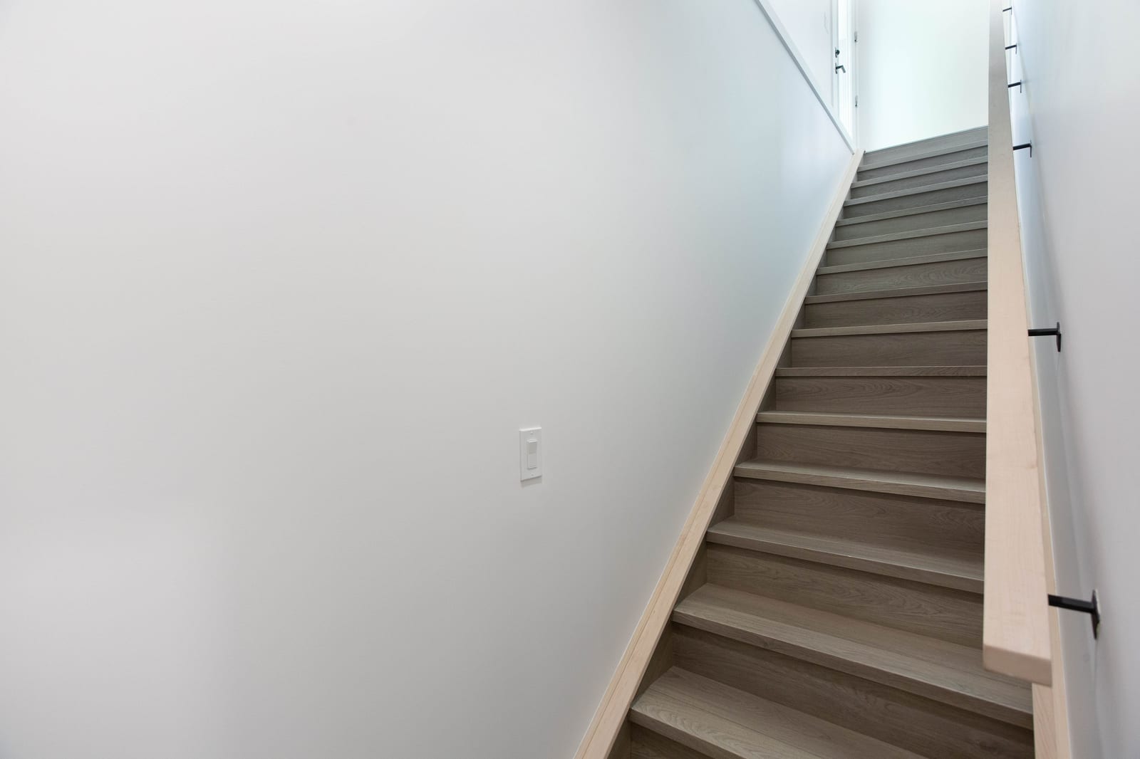 Staircase to the lower level — supplied paired-home gallery; confirm 1106 finishes